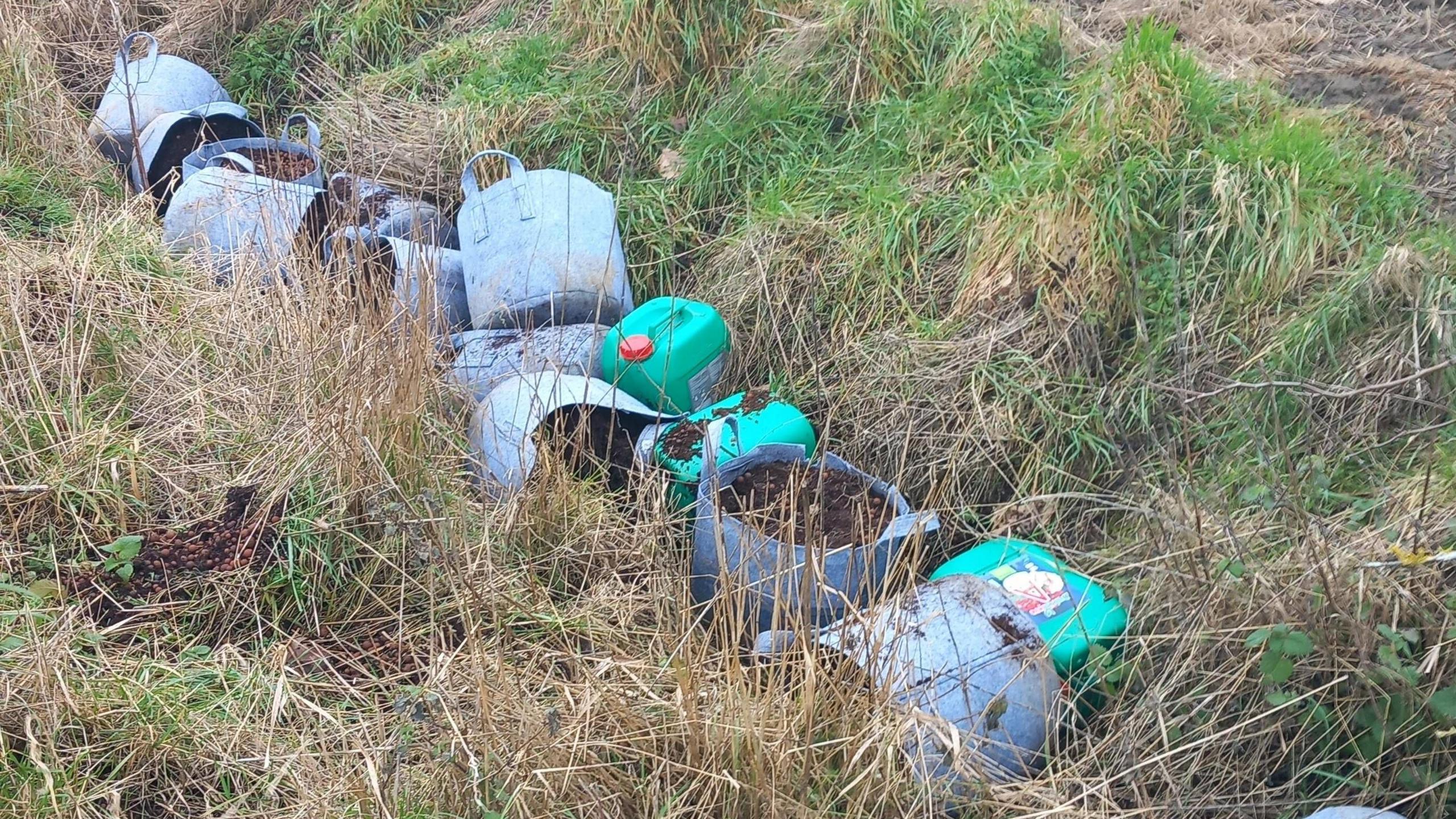 Waste materials have been dumped and left in a ditch in a Cambridgeshire village. Bottles of fertiliser and other containers have been dumped. 