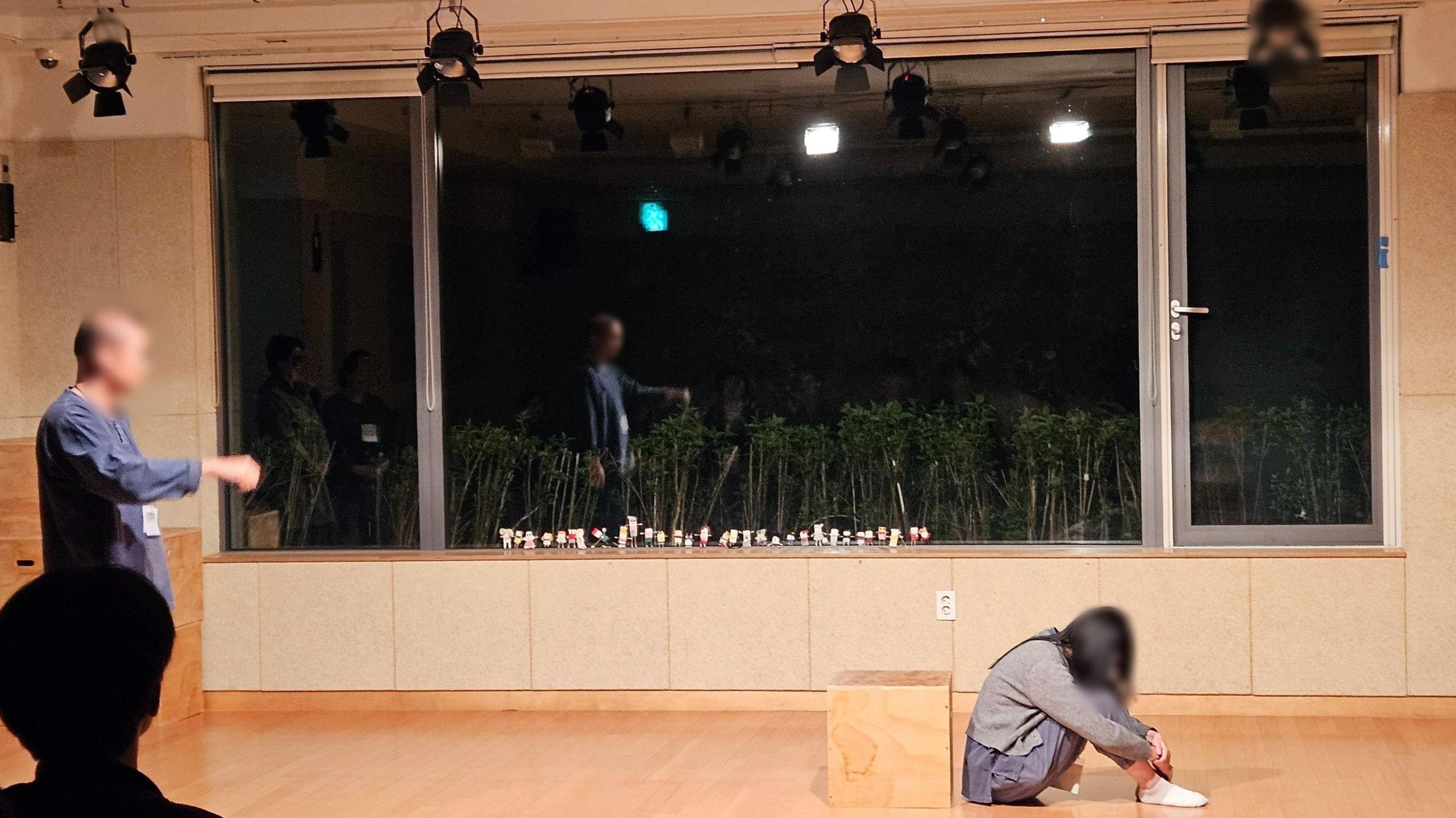 A woman sits on the floor reflecting