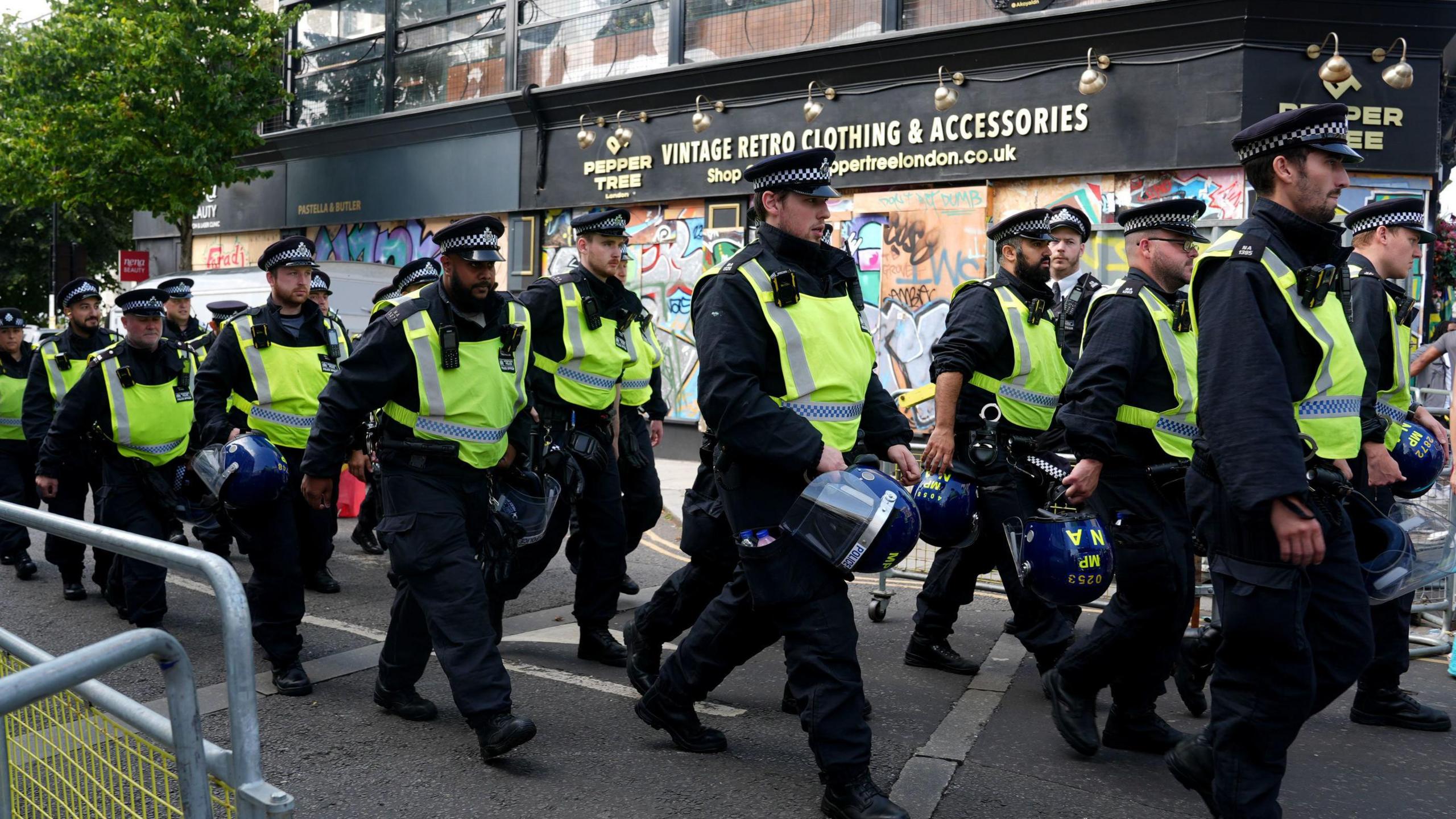 Police officers on Ladbroke Grove during Notting Hill Carnival on 26 August 2024.