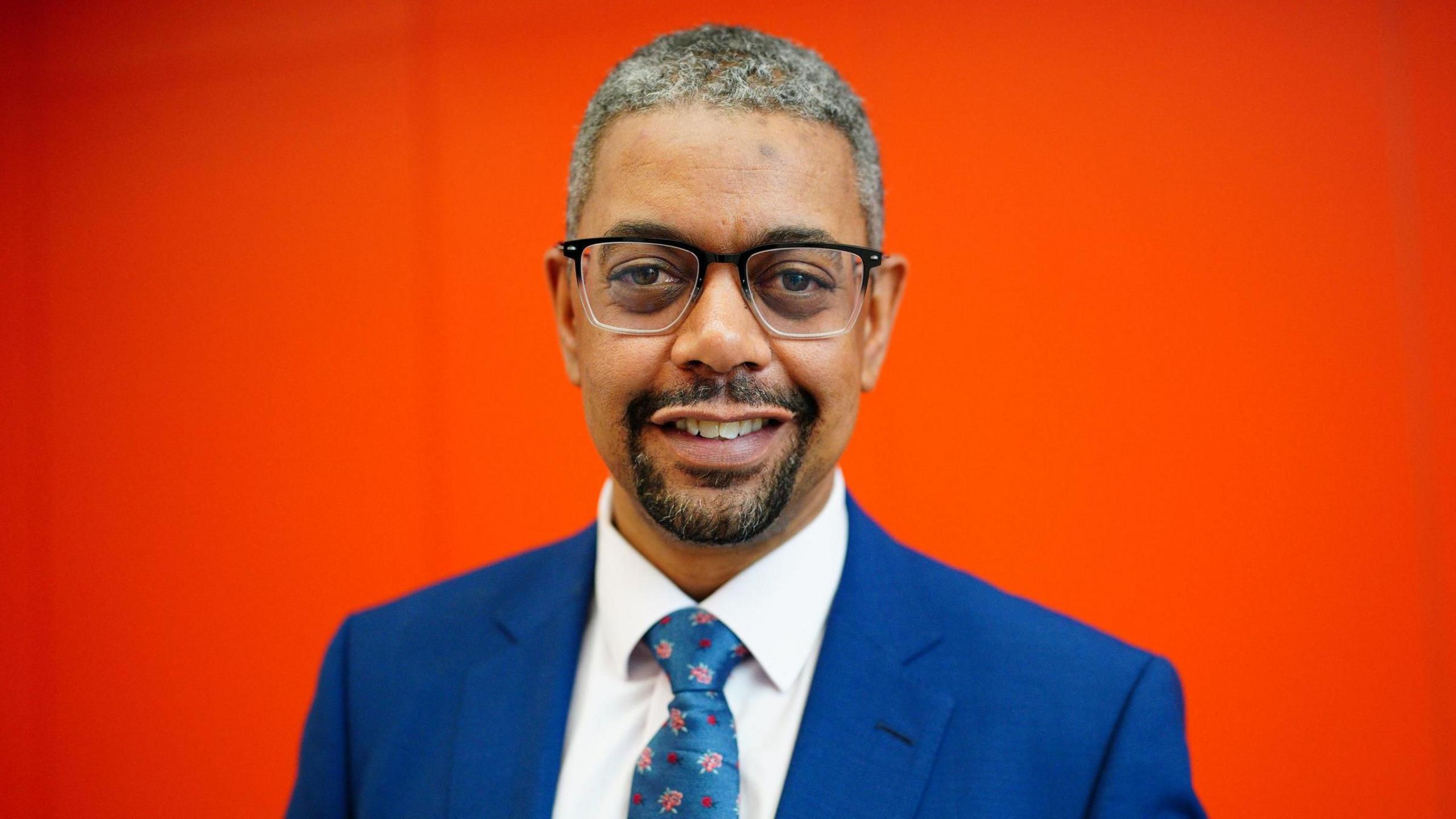 Vaughan Gething smiling while wearing a blue suit