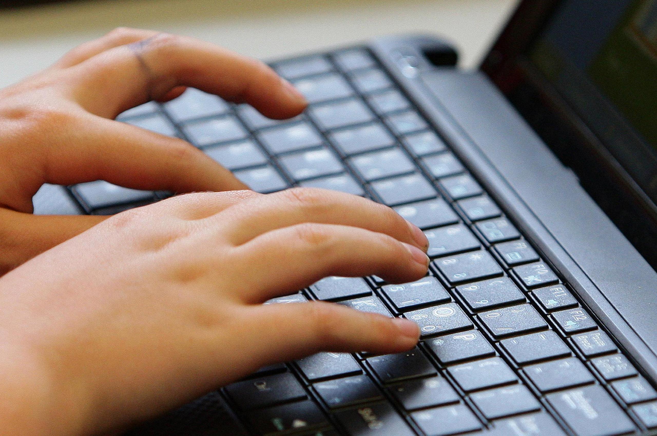 Hand typing on keyboard