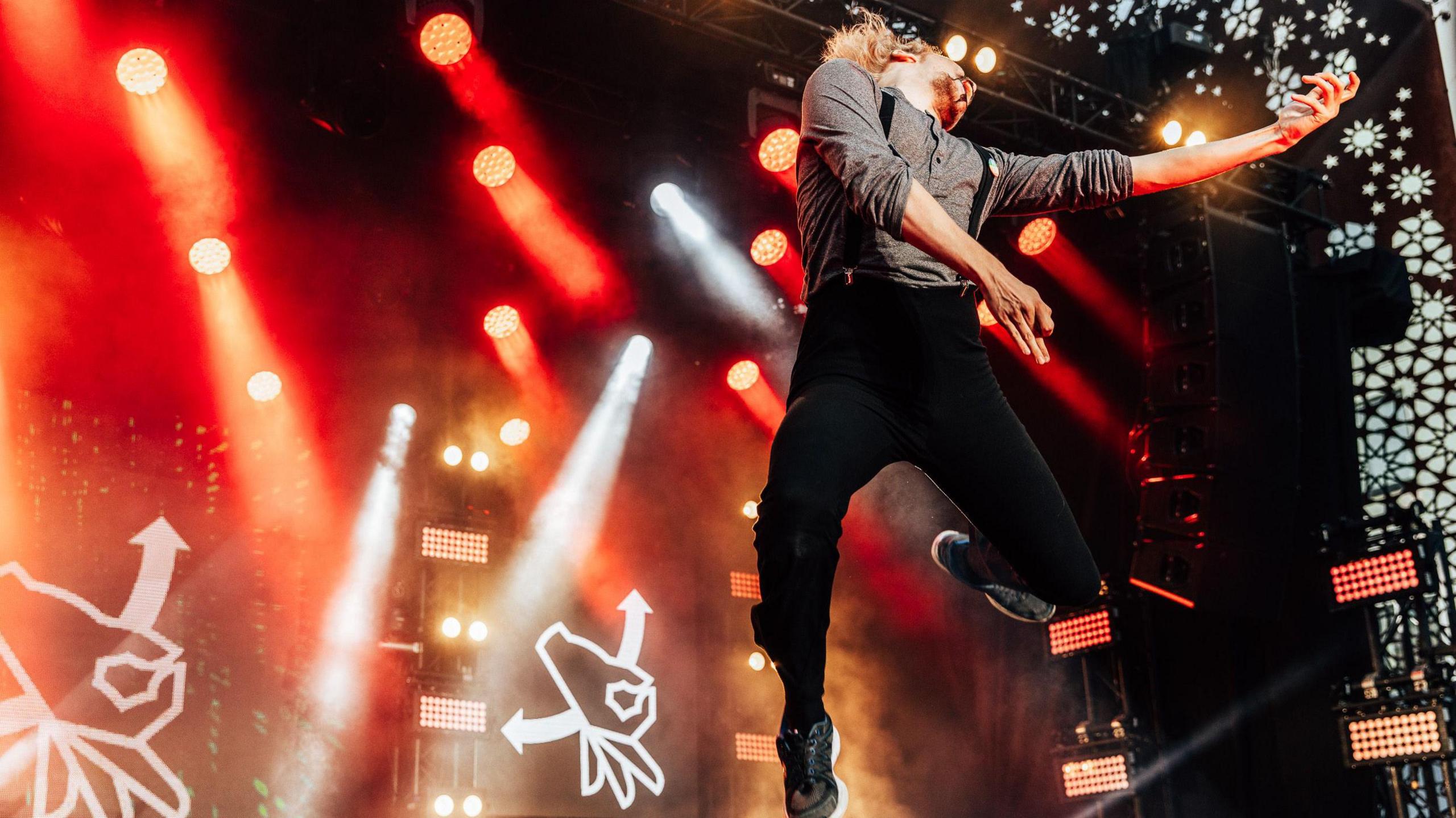 Aapo "The Angus" Rautio leapign into the air during his air guitar performance.