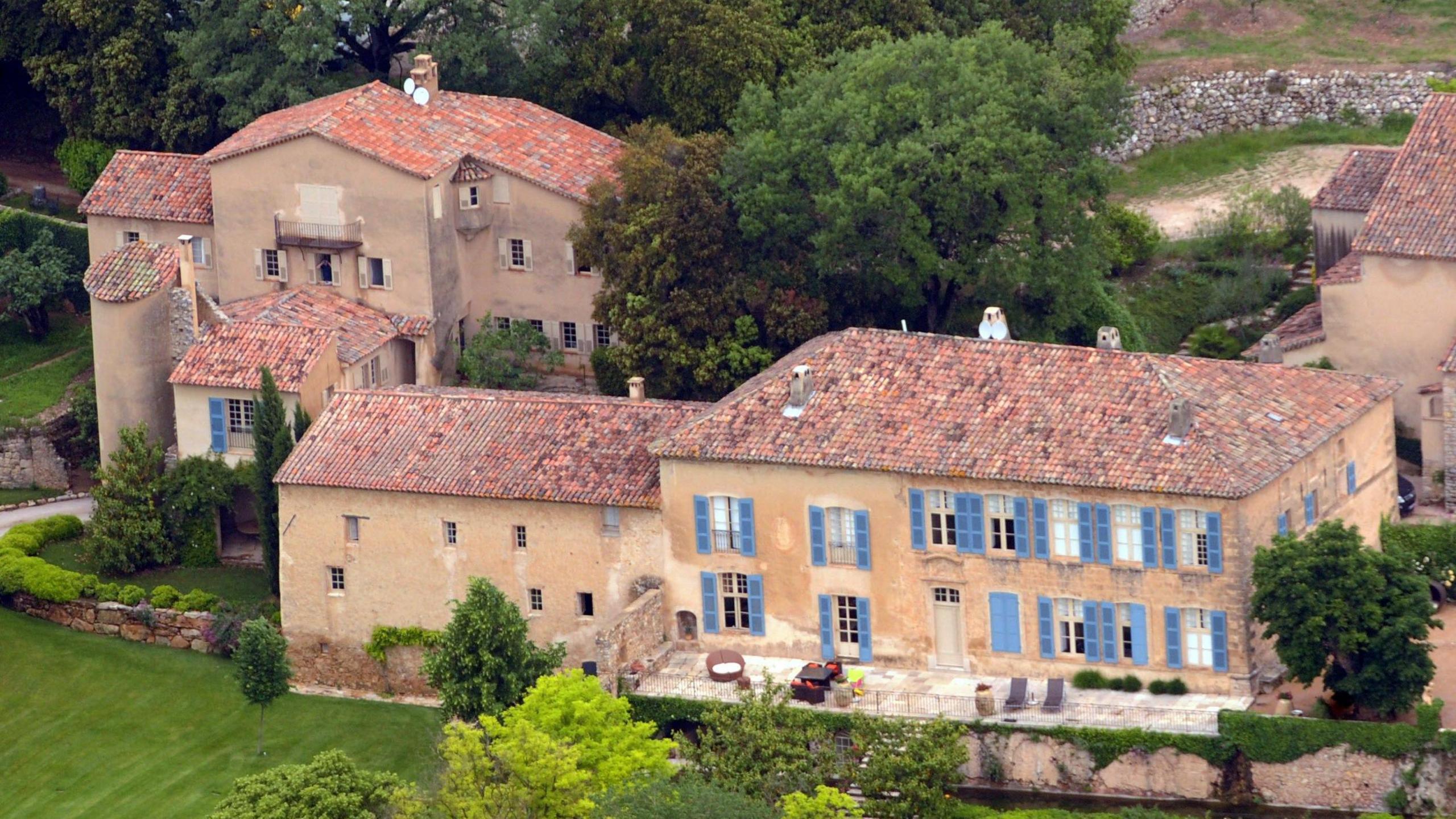 Chateau Miraval is in south east France, the buildings are traditional with blue shutters