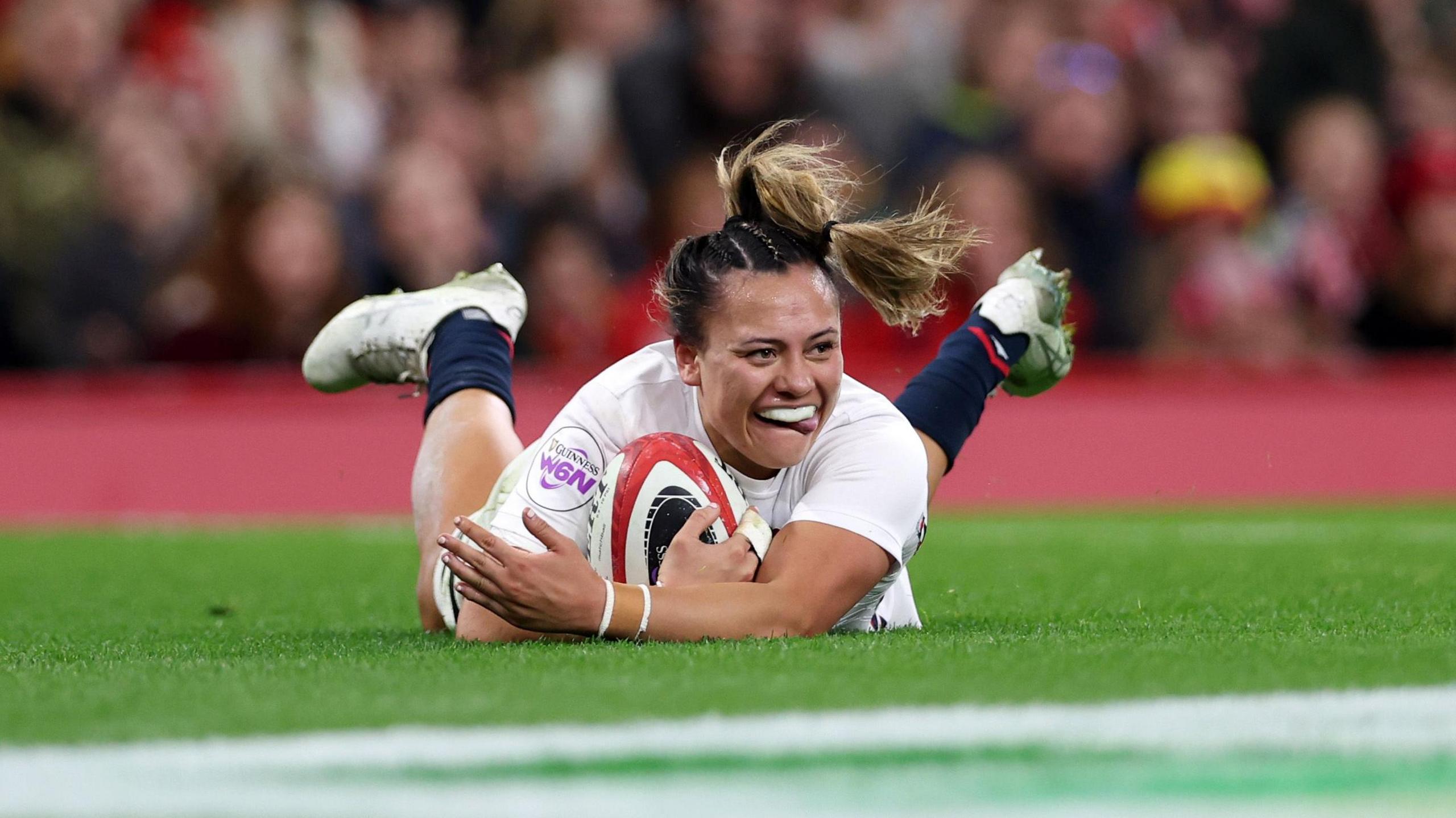 Maddie Feaunati scores a try for England