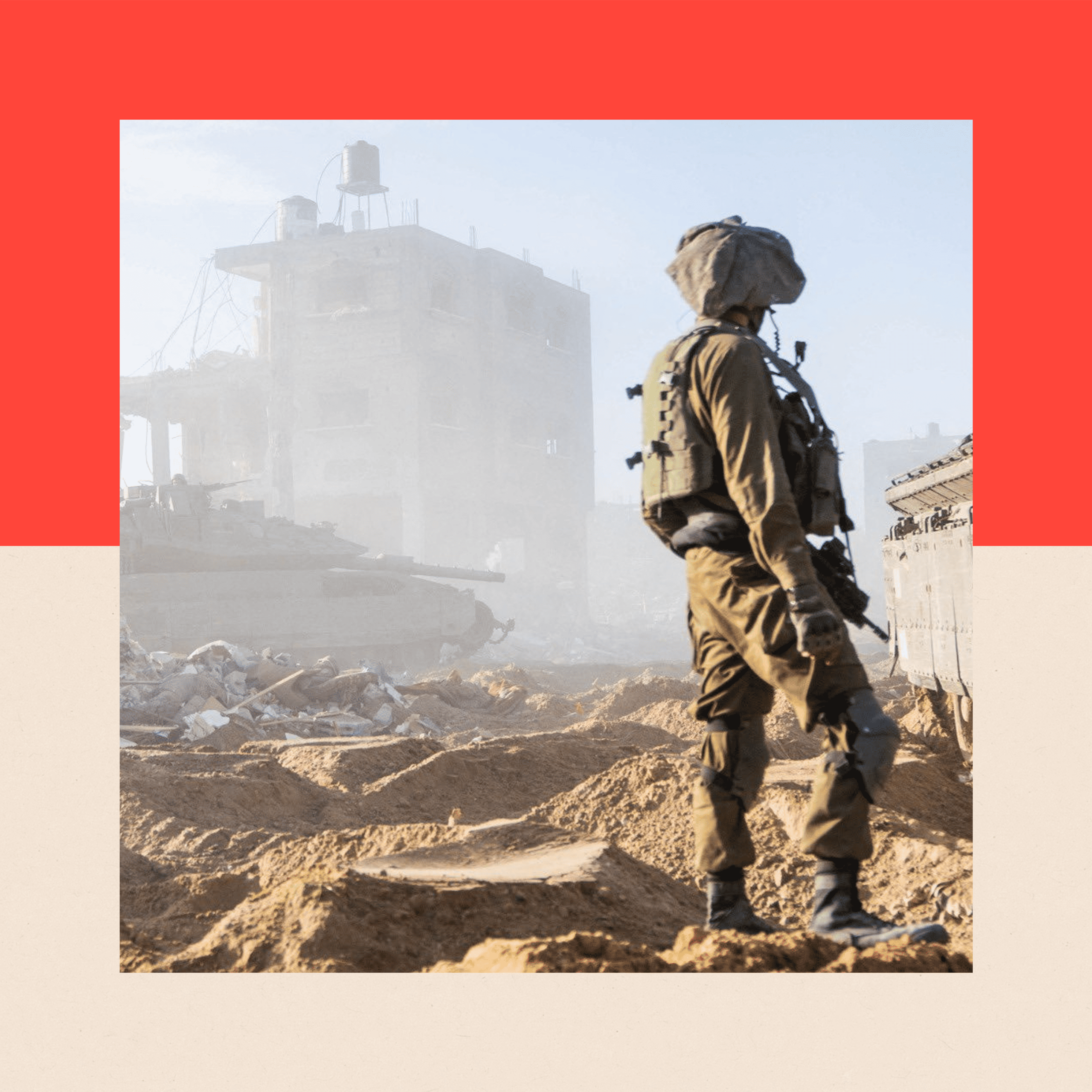 A soldier in uniform stands amidst rubble in the Gaza Strip, his back turned to the camera