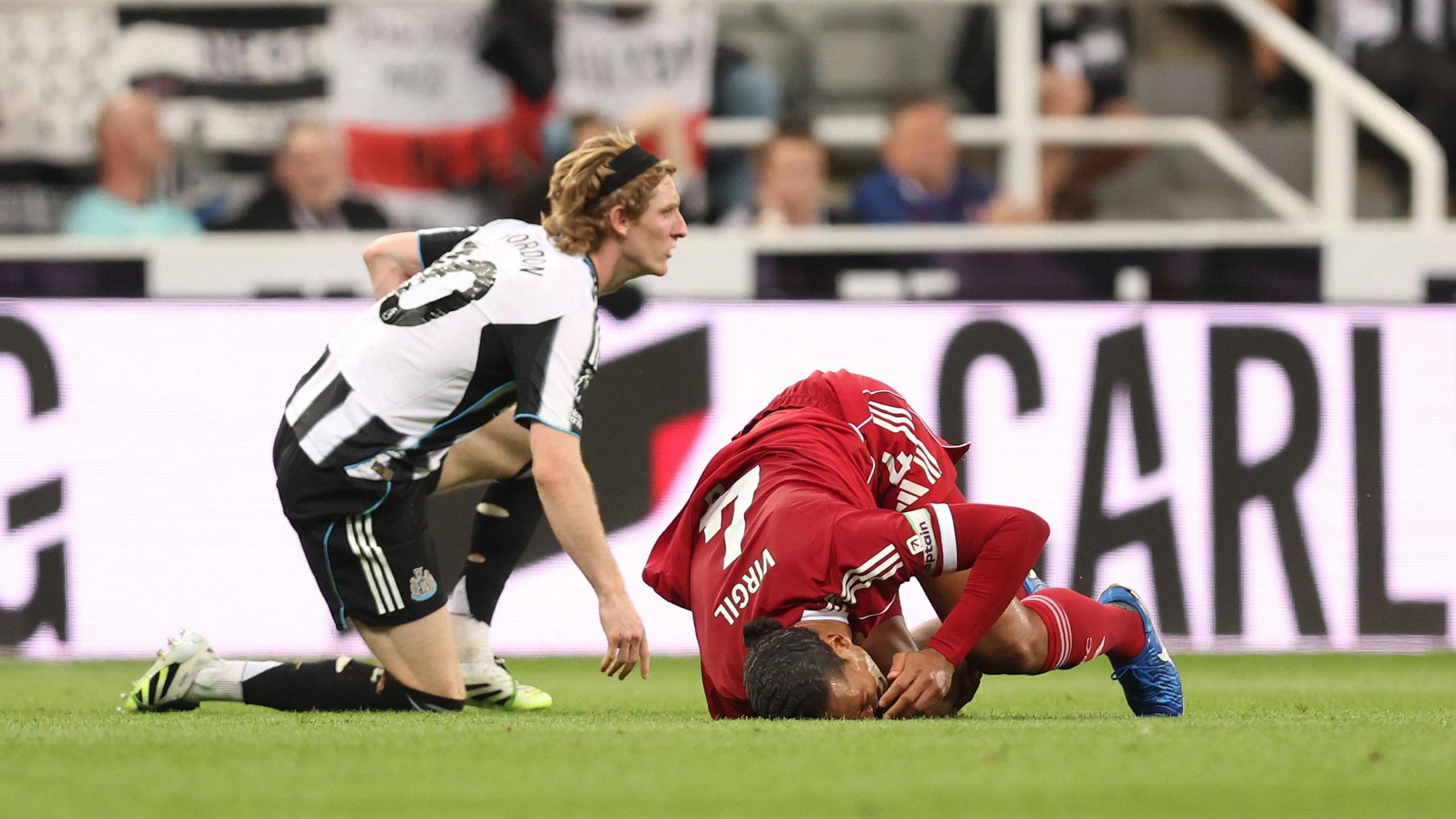 Anthony Gordon fouls Virgil van Dijk