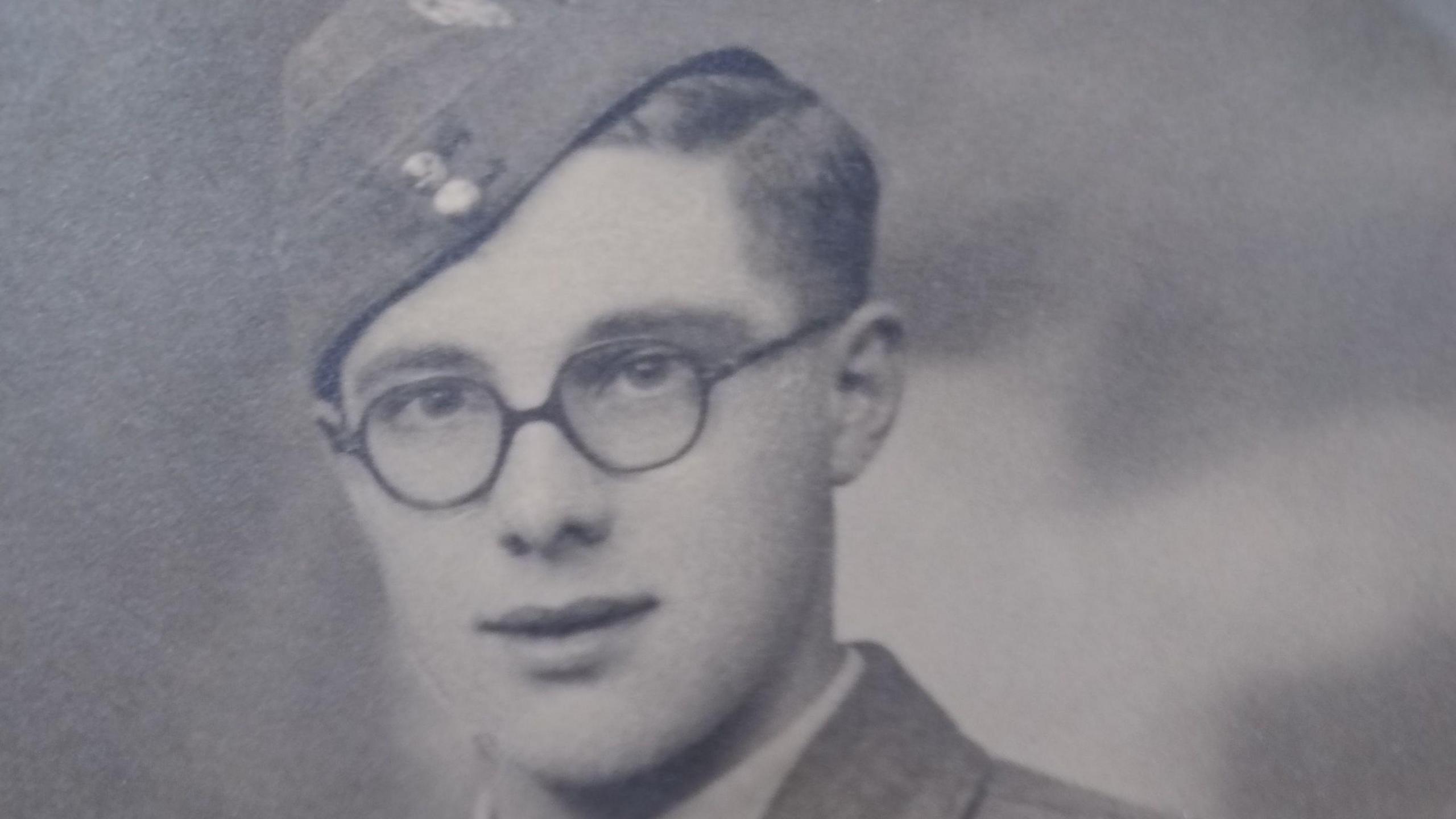 A young Alan in 1942. He is wearing a military uniform with glasses.