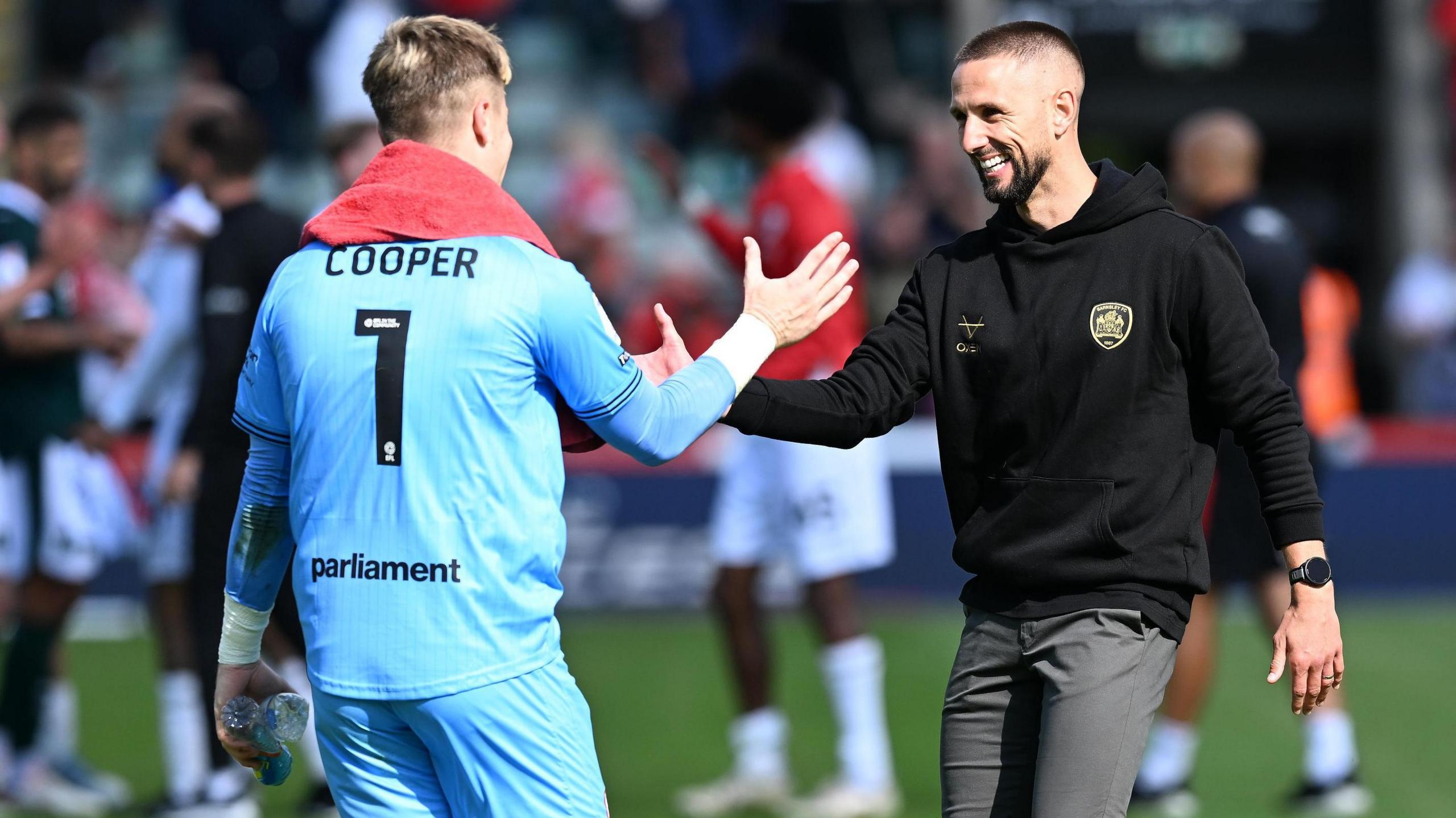 Murphy Cooper is congratulated by boss Conor Hourihane after Barnsley's win