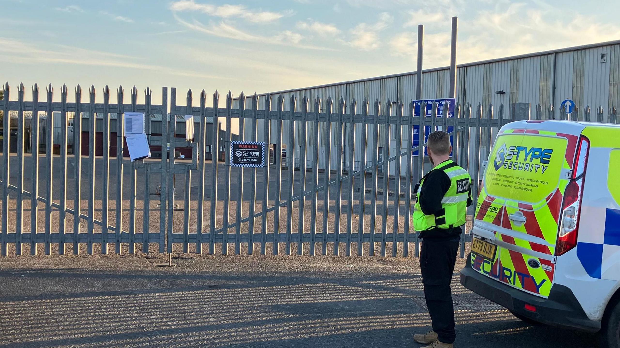 The test centre with a guard in a high-visibility vest stationed outside