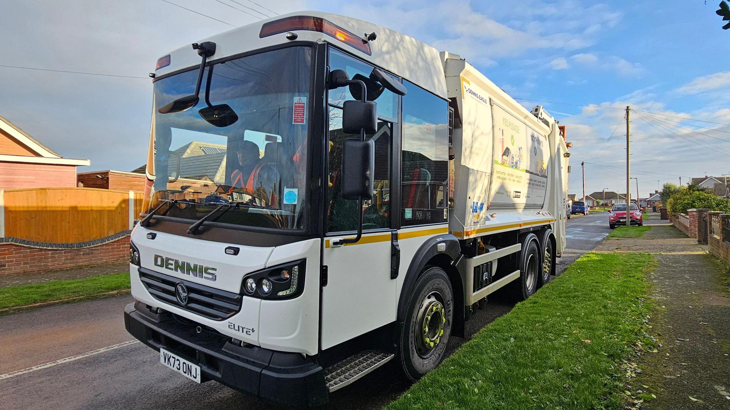 A white bin lorry on a residential street in Great Yarmouth.