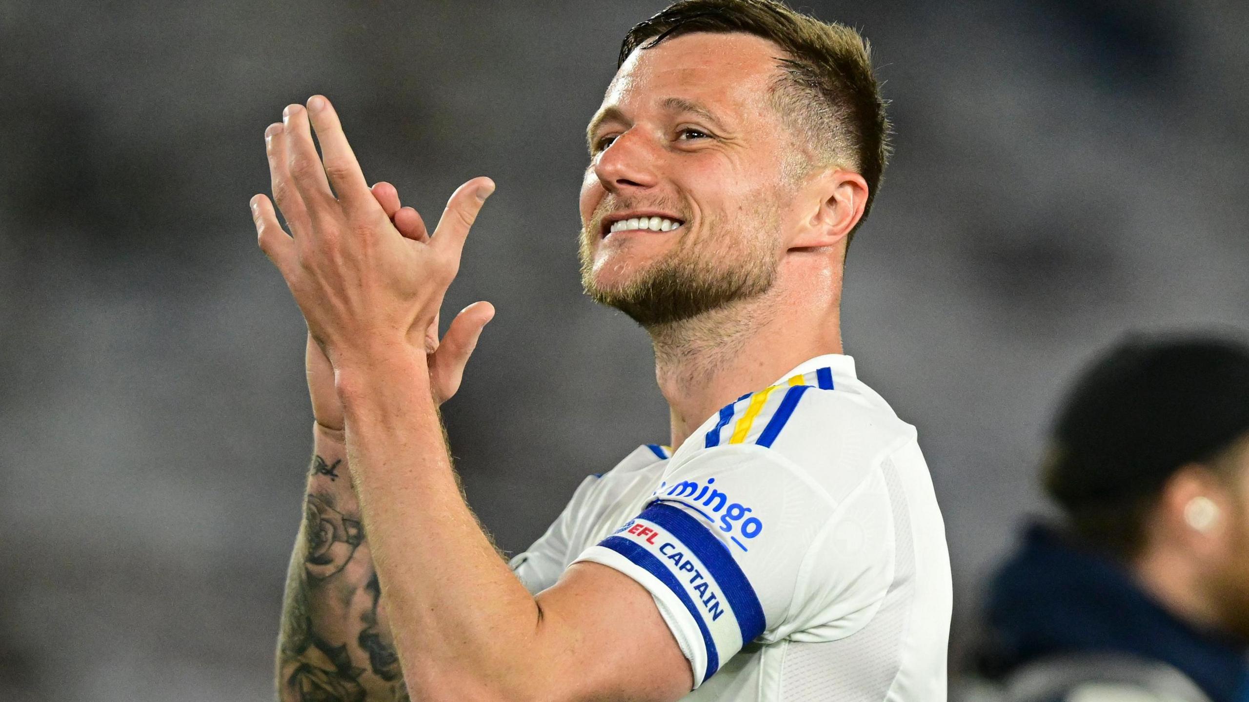 Liam Cooper applauds the Leeds fans