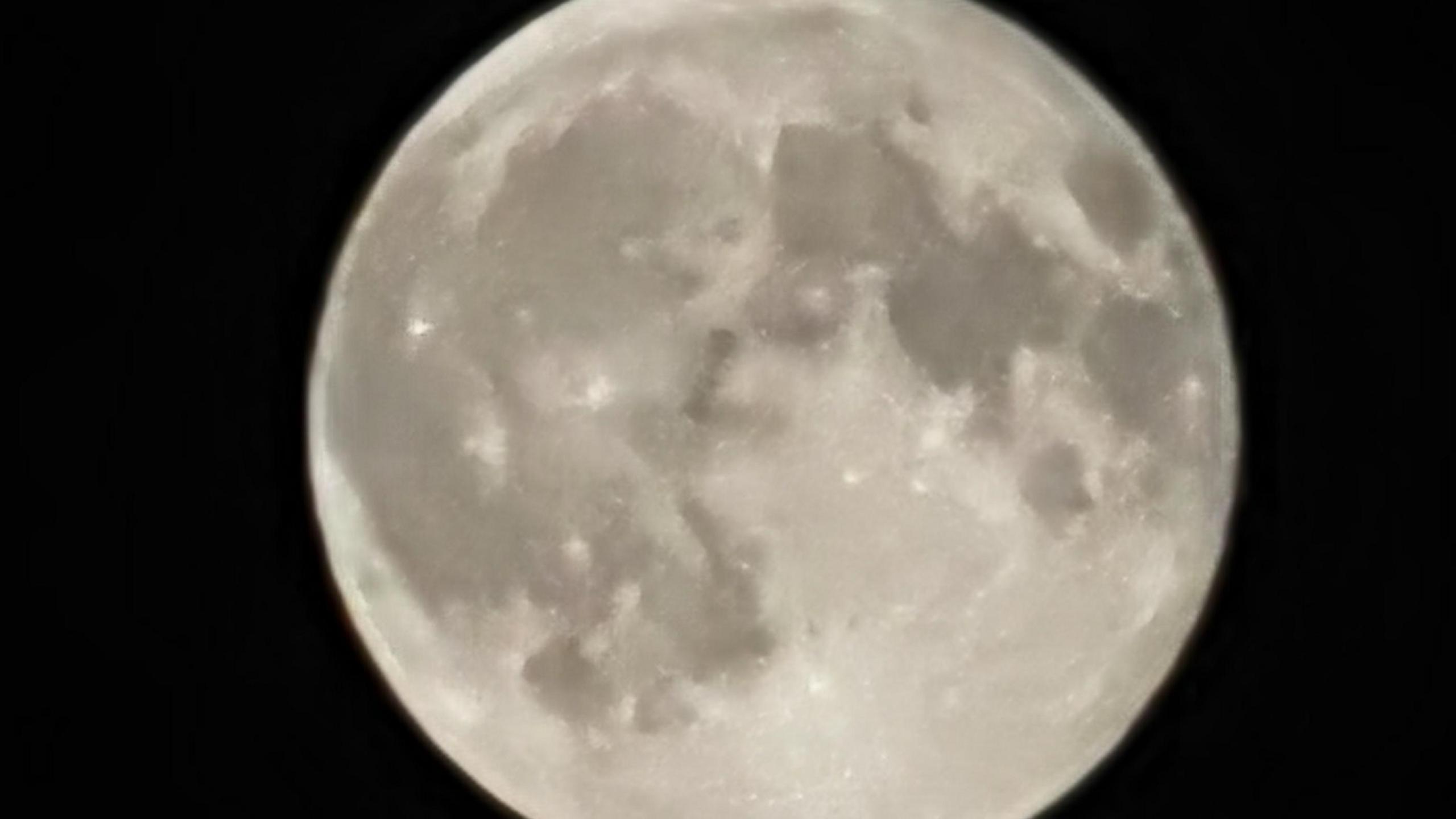 A generic-looking moon which is white or grey in colour against a black backdrop. 