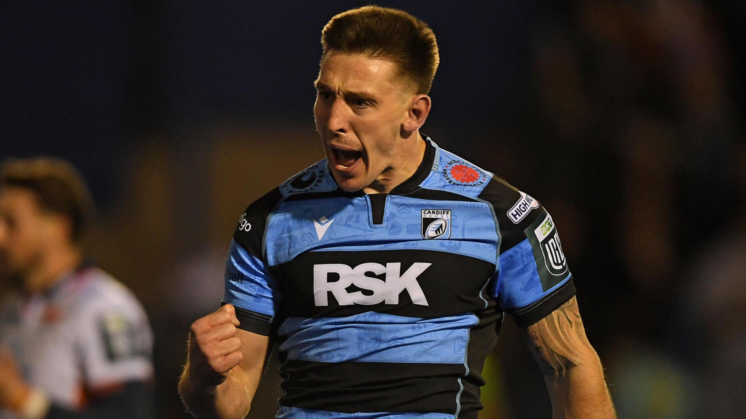 Josh Adams celebrates scoring a try for Cardiff