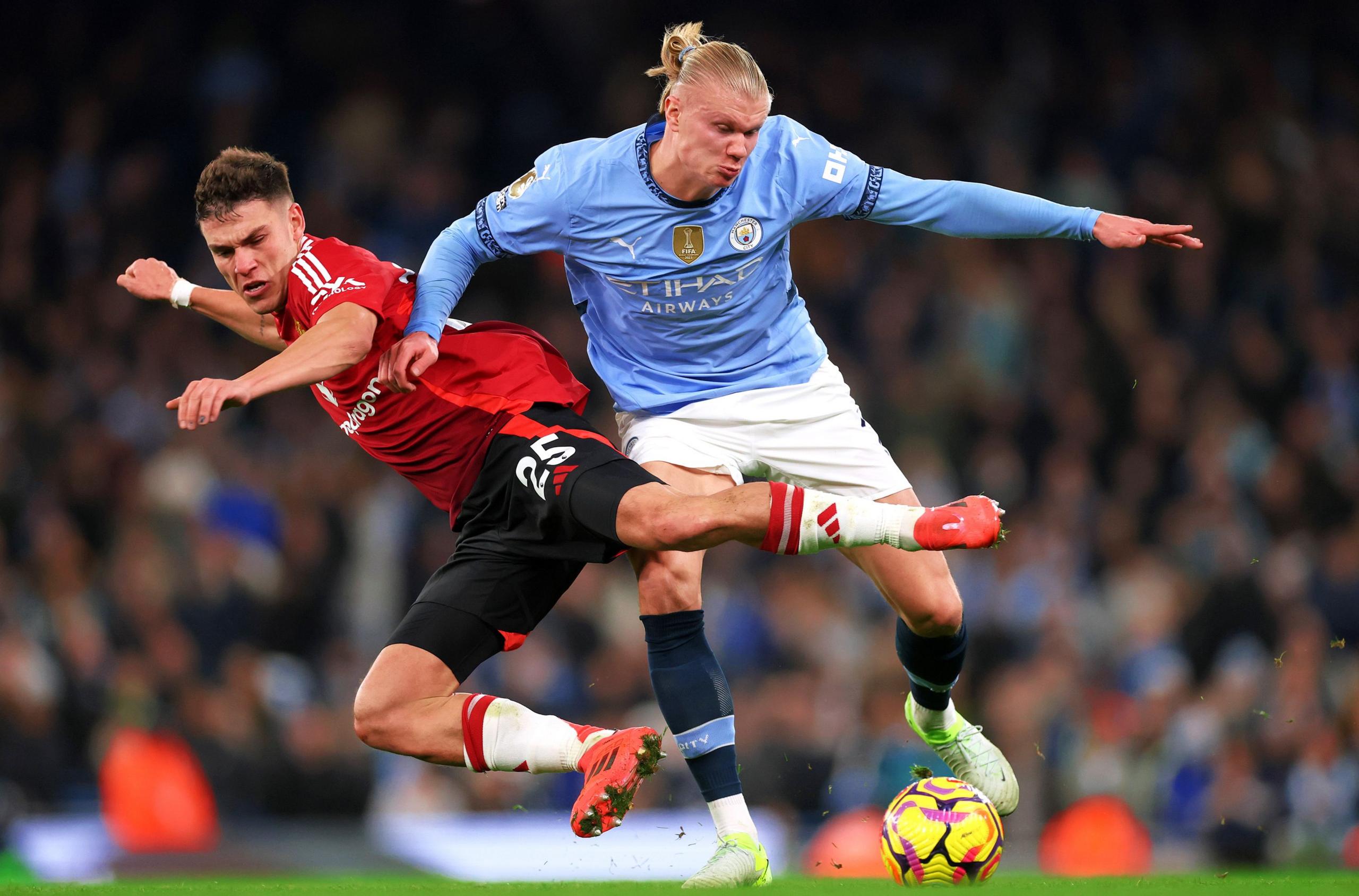 Manuel Ugarte of Manchester United and Erling Haaland of Manchester City battle for possession during the Premier League match between Manchester City FC and Manchester United FC at Etihad Stadium