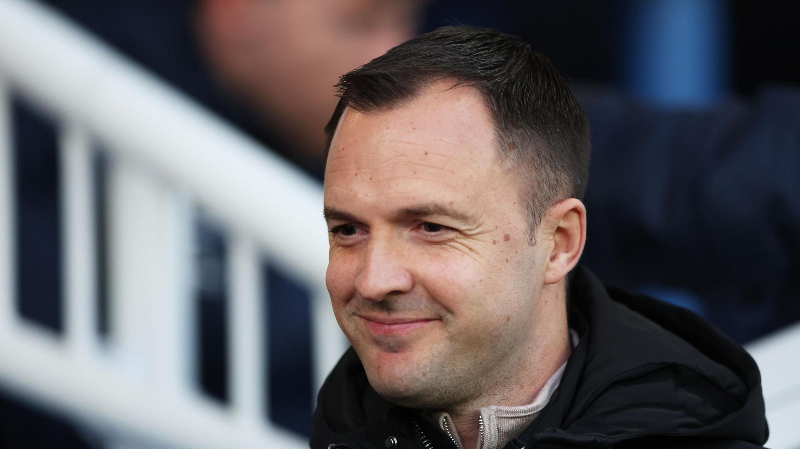 Birmingham City boss Chris Davies smiling on the touchline.