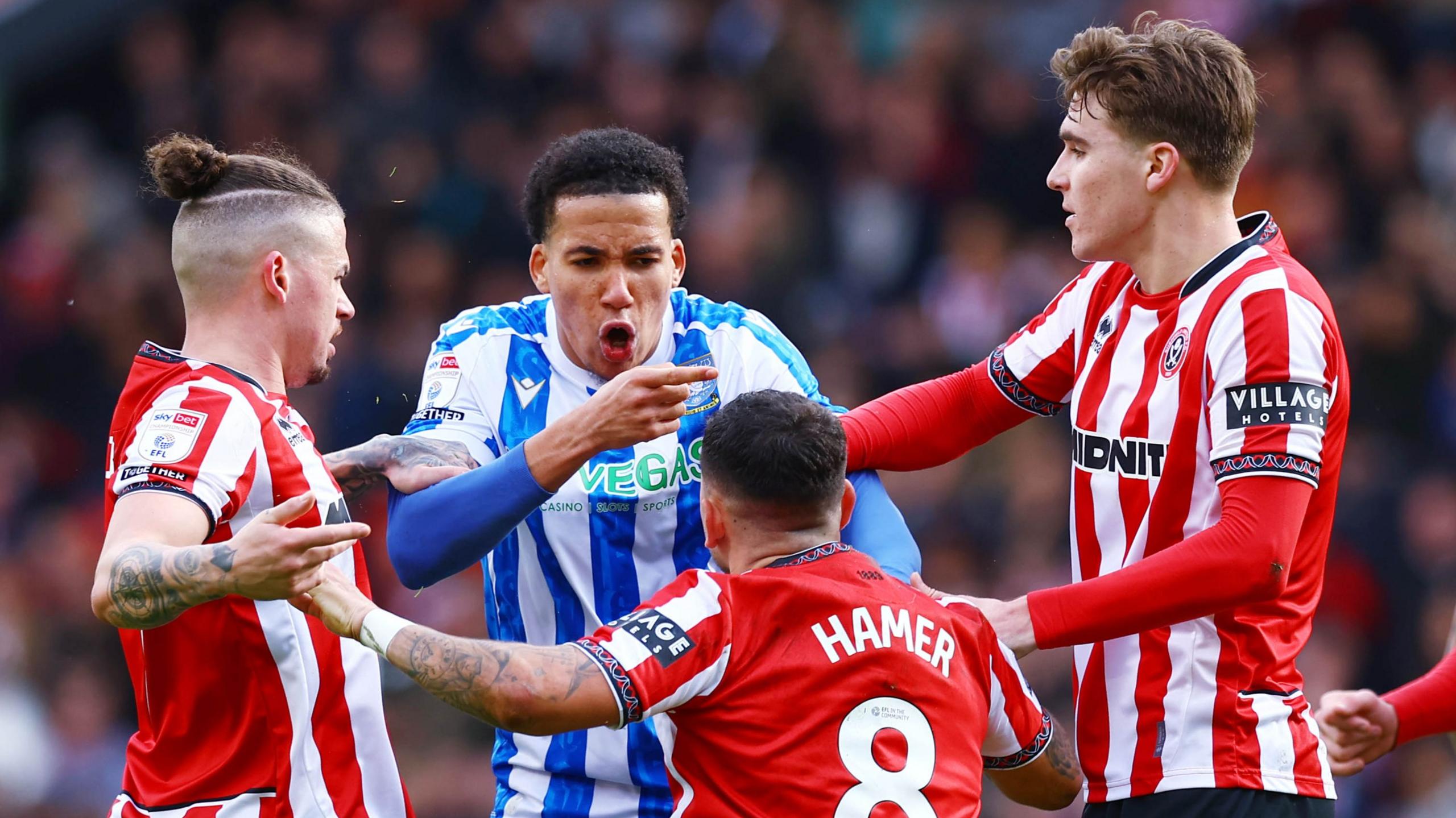 Sheffield United and Sheffield Wednesday players come together during the derby