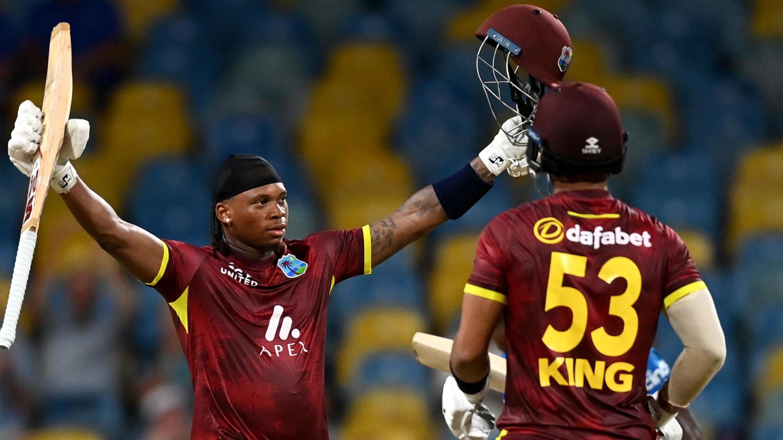 Keacy Carty of the West Indies celebrates his century with Brandon King.