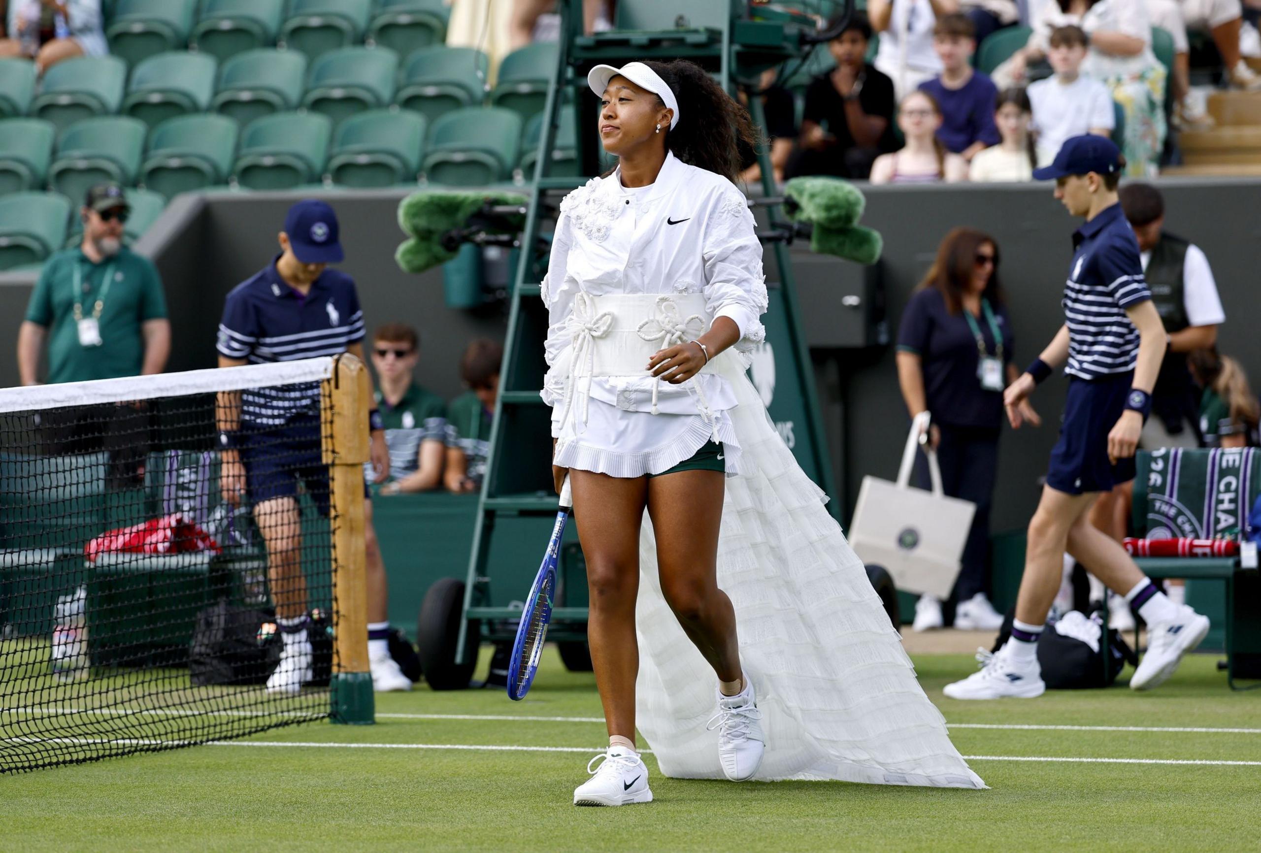Naomi Osaka wearing her latest outfit at Wimbledon, featuring a train and traditional obi