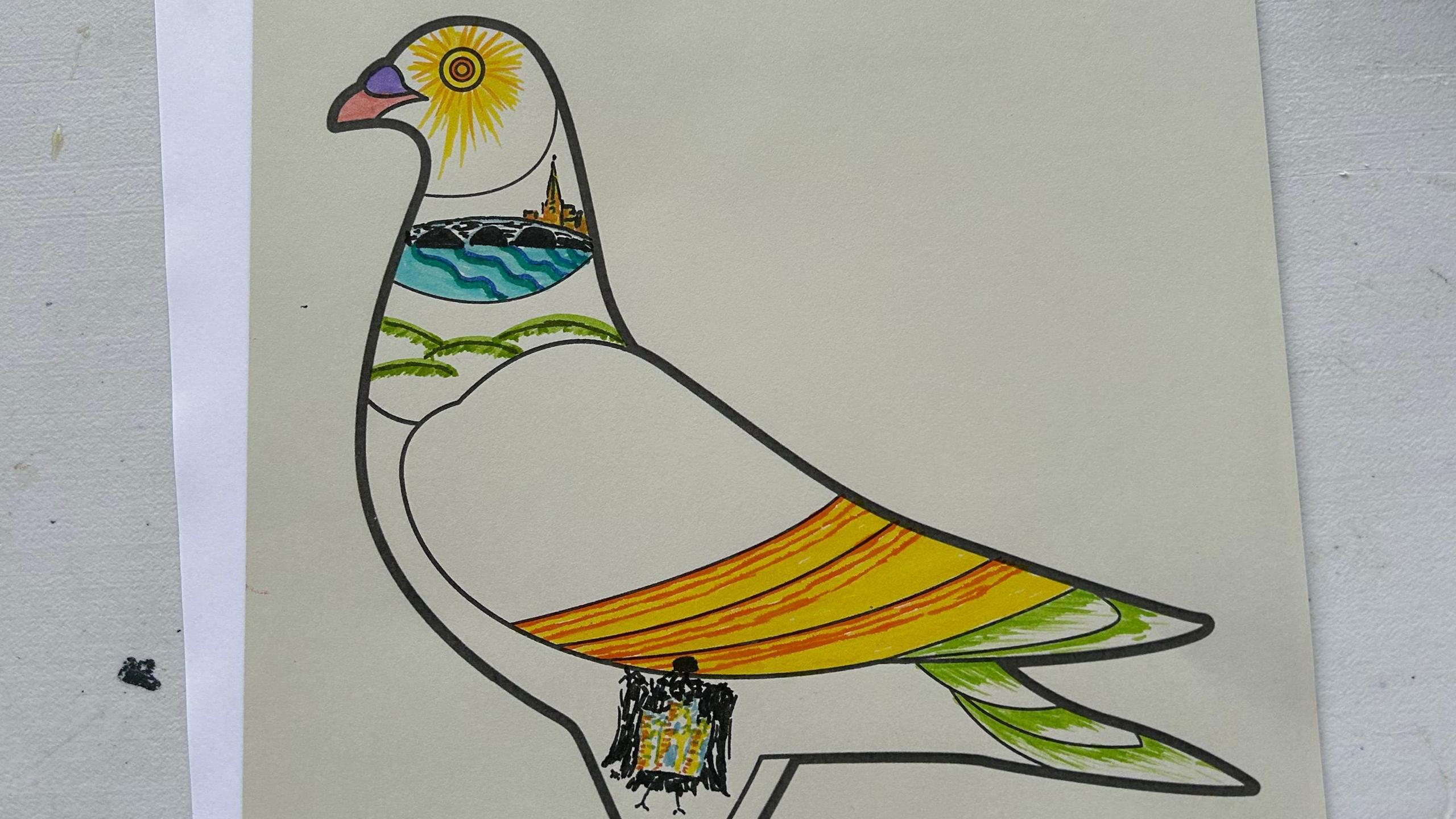 A paper template of a pigeon with drawings of a church and yellow and green banding.