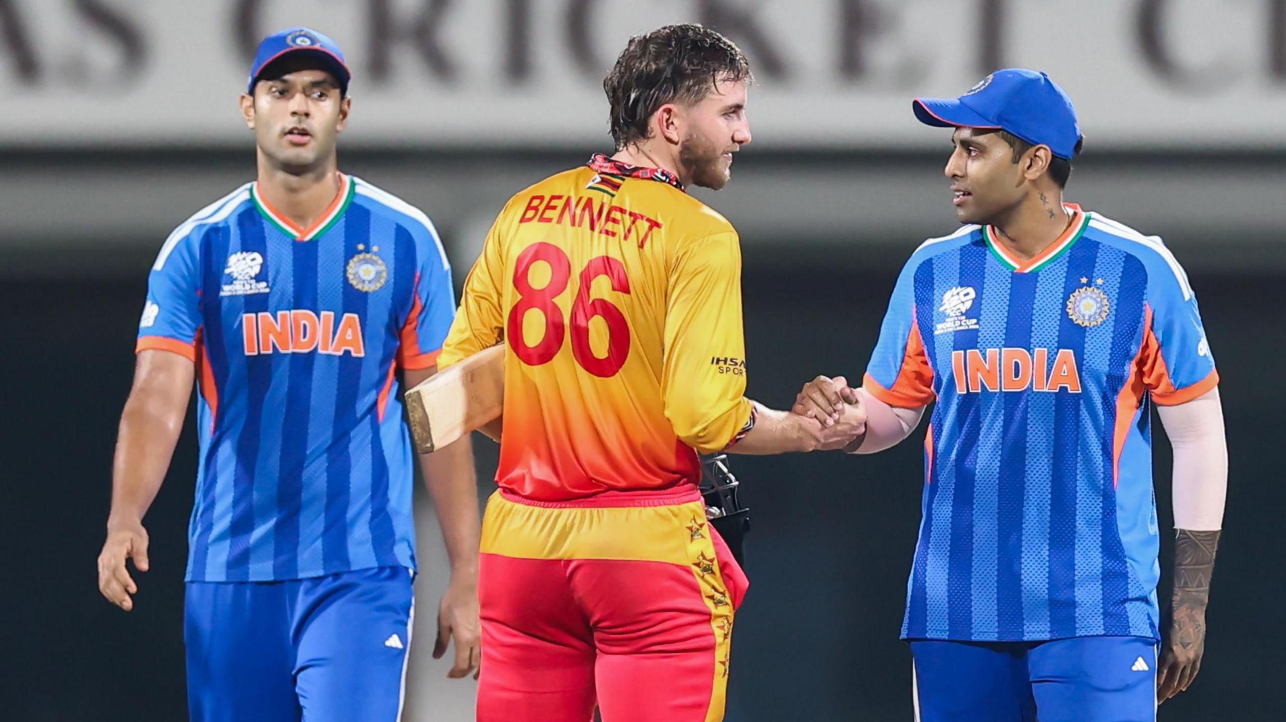 Zimbabwe's Brian Bennett shakes hands with India's Suryakumar Yadav after a T20 World Cup game in 2026