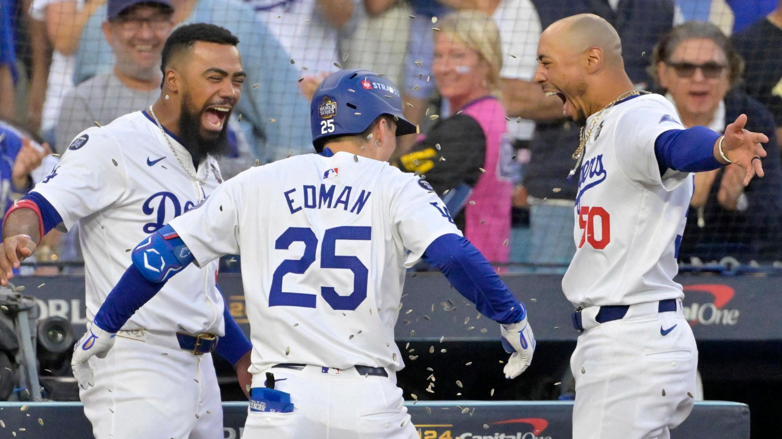 Teoscar Hernandez, Tommy Edman and Mookie Betts celebrate a home run by the Los Angeles Dodgers