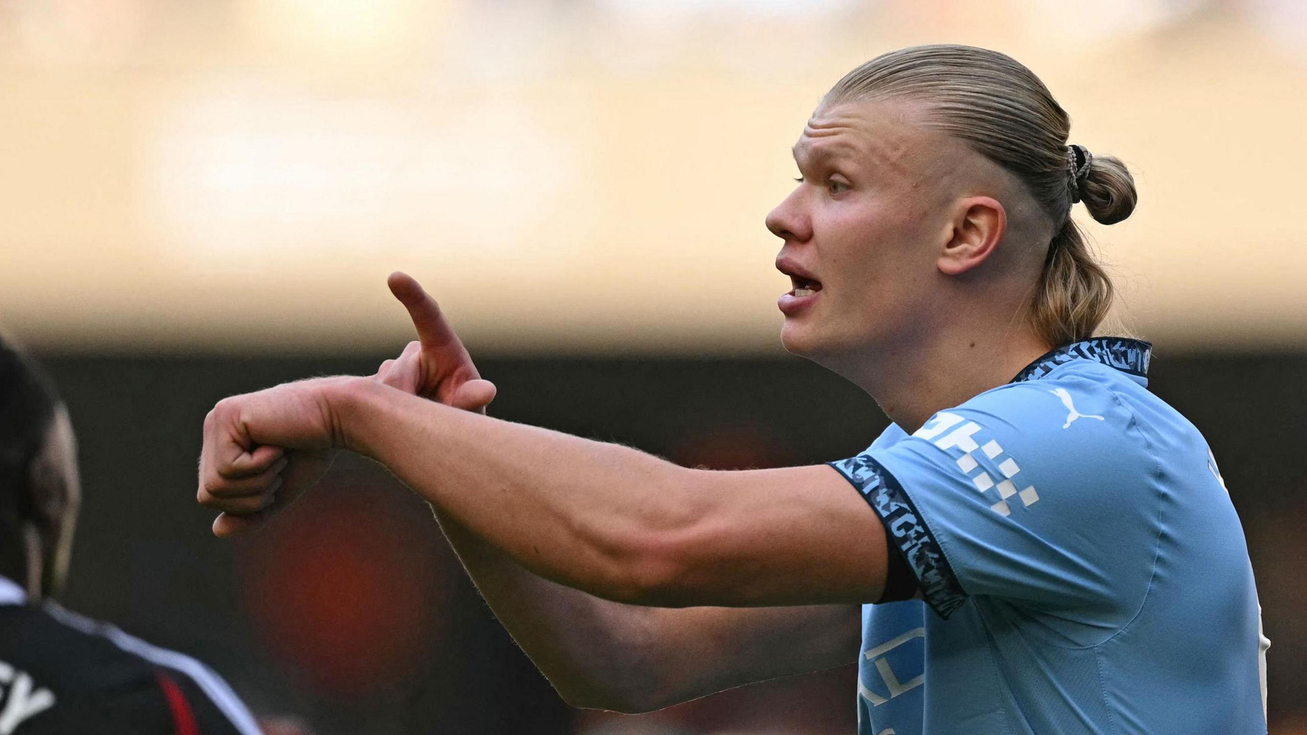 Manchester City's Erling Haaland gestures to an assistant referee about time-wasting