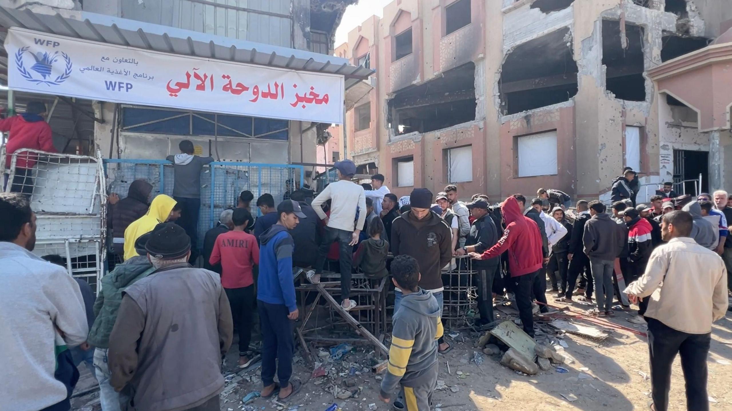 Palestinians queue at a bakery in Khan Younis, southern Gaza