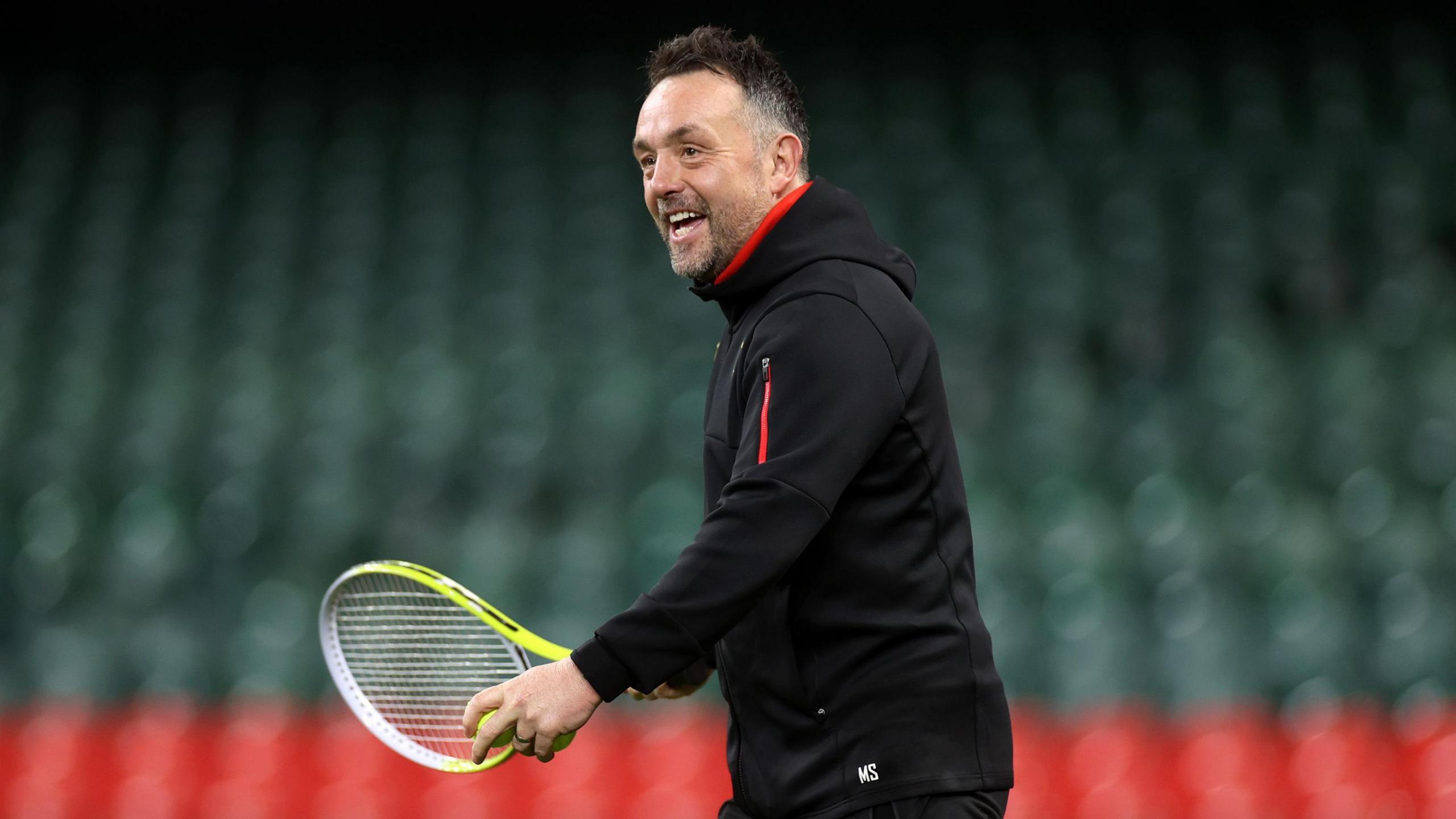 Matt Sherratt with a tennis racquet at the beginning of a training session