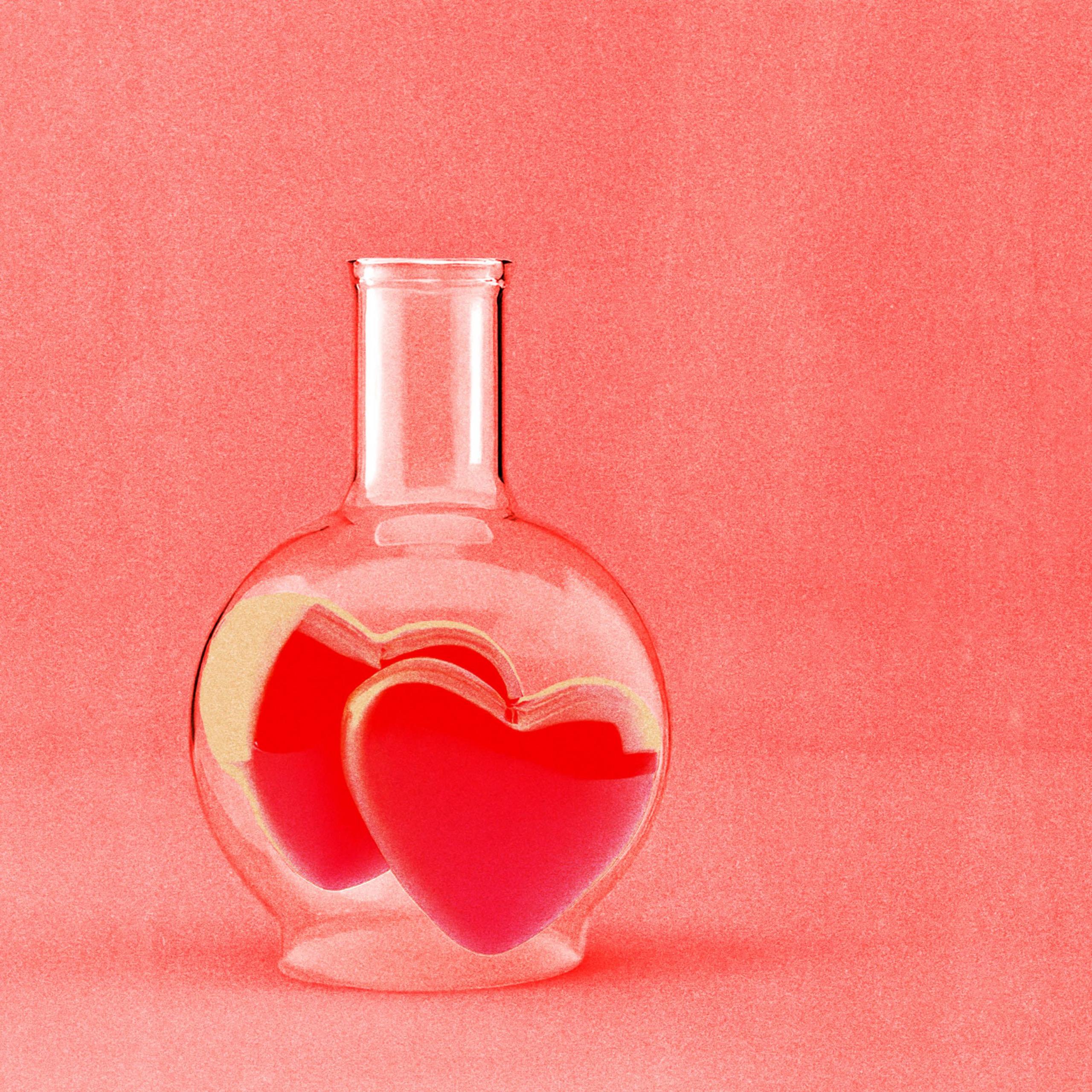 A treated image of a glass beaker with two hearts inside