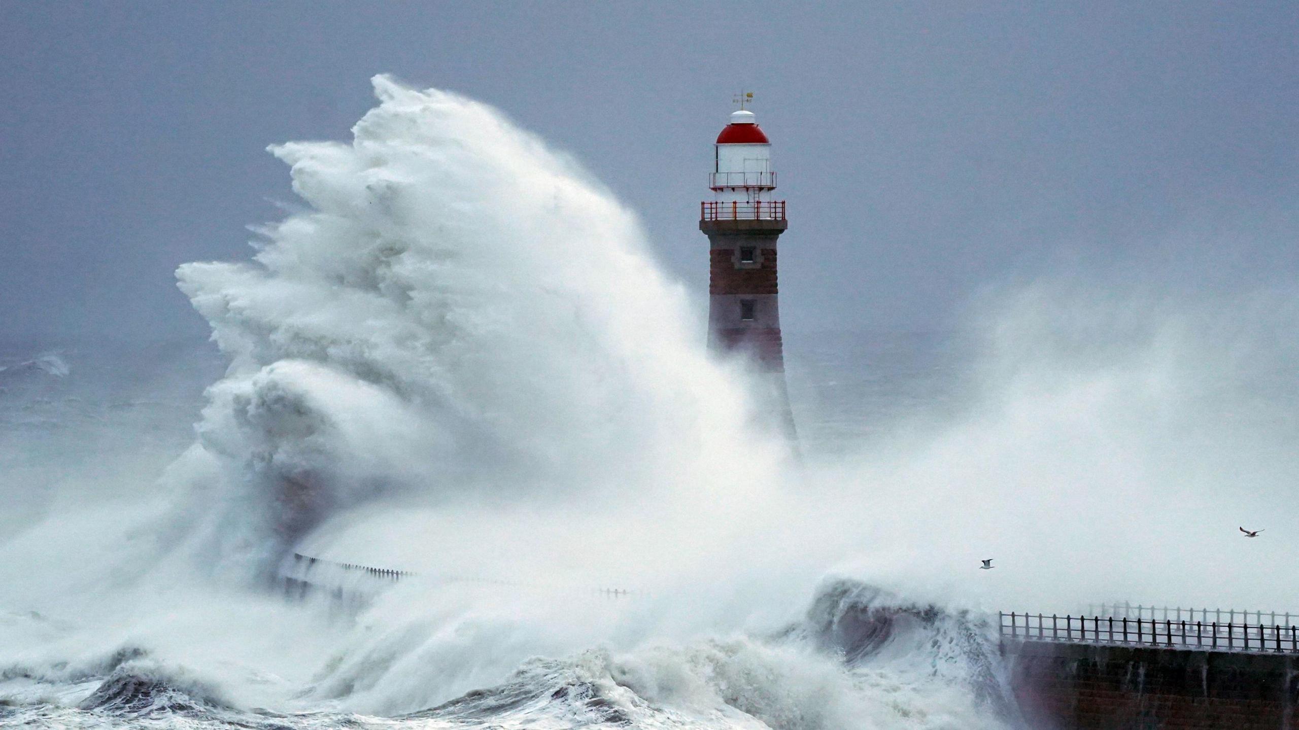 Waves crashing against the lighthouse at the end of Roker Pier.