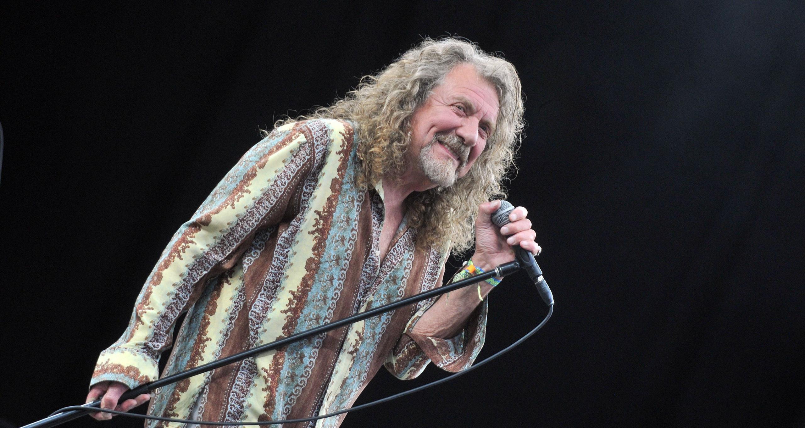 Robert Plant holding his mic stand