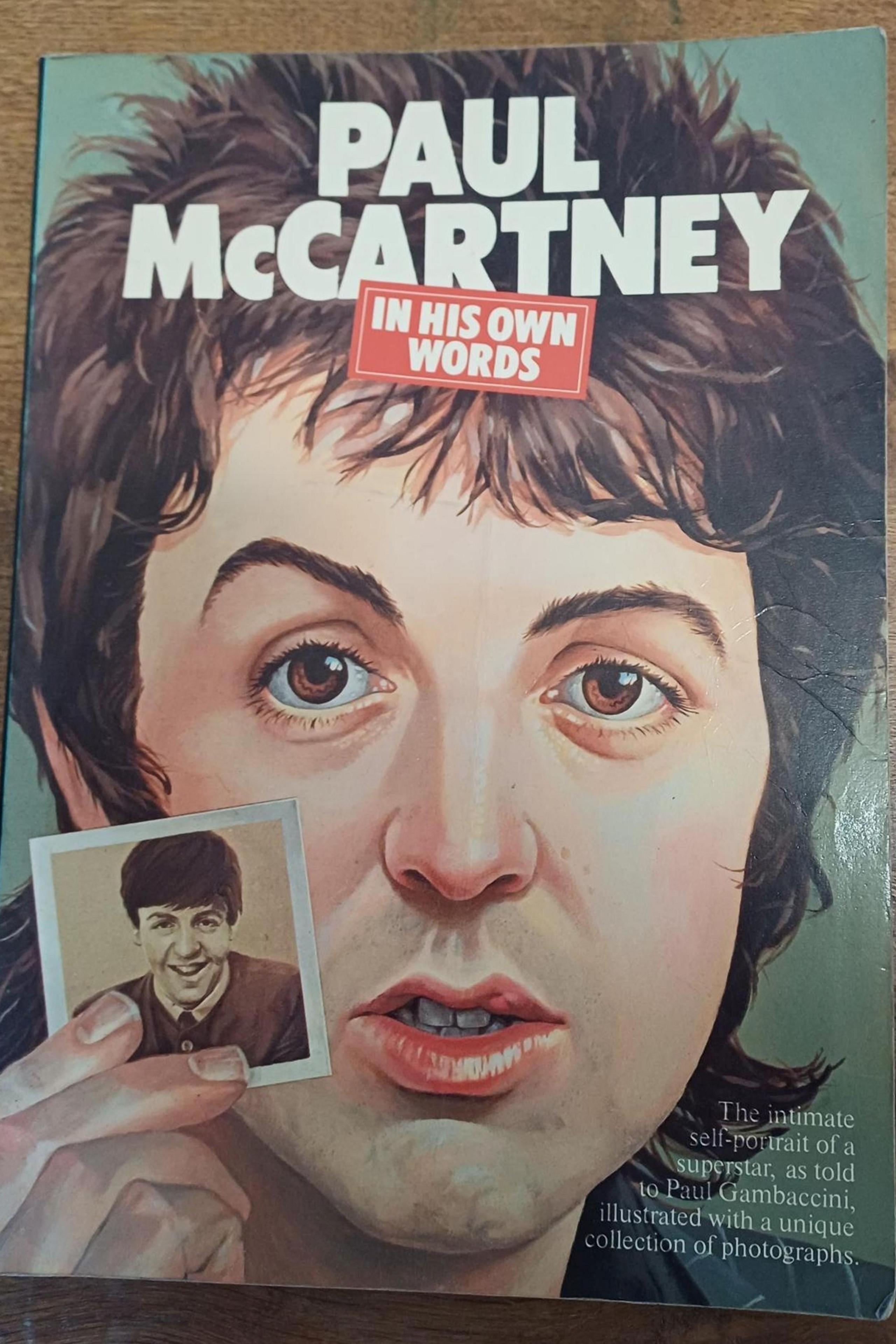 Front cover of the Paul McCartney book. It has a cartoon image of Paul McCartney holding a photo inset of himself.