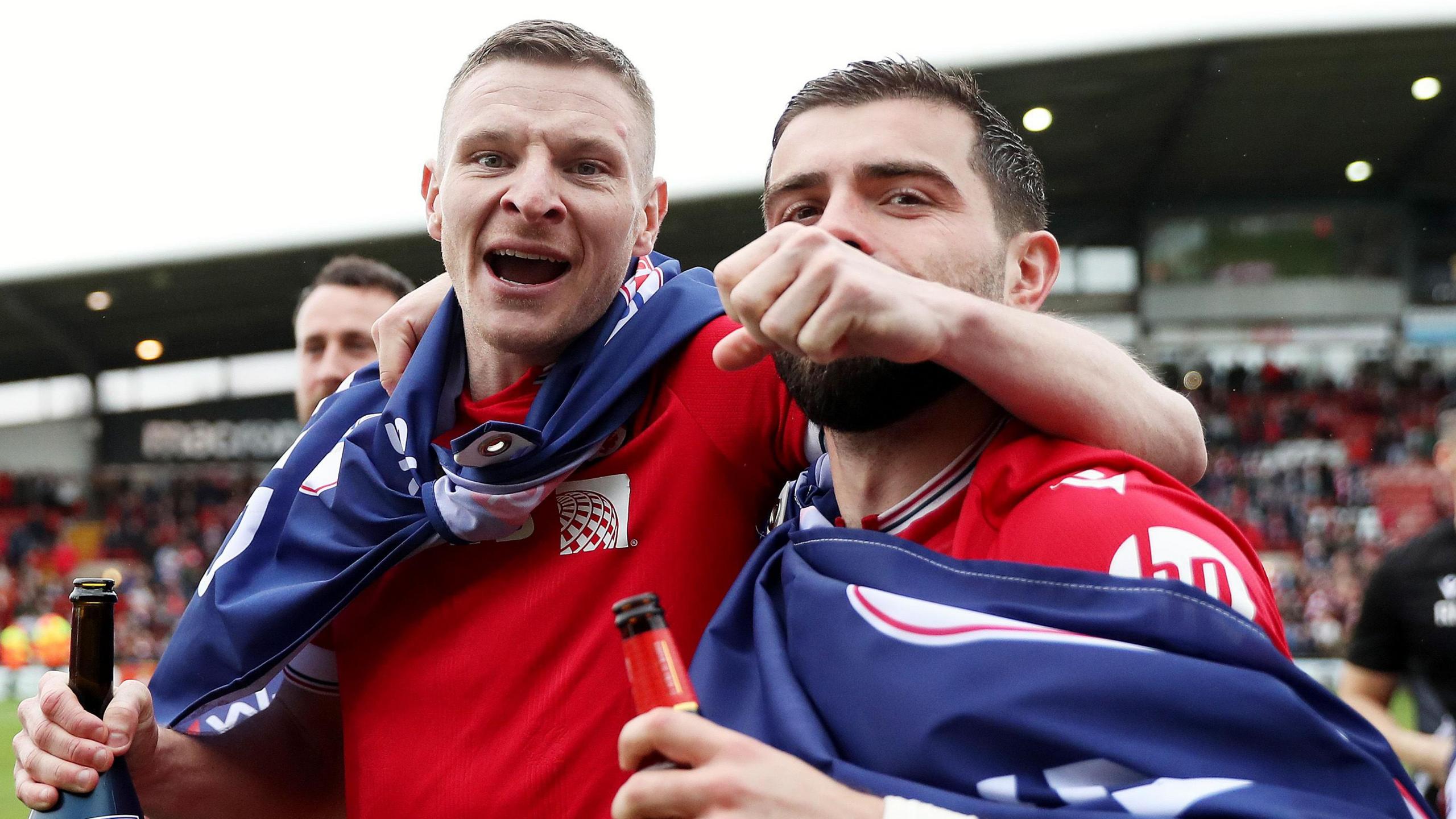 Paul Mullin celebrates promotion to League One with Elliot Lee (right)
