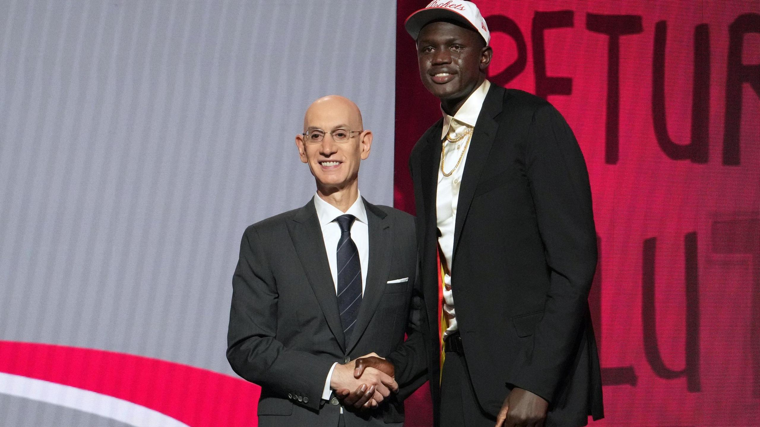Adam Silver shakes hands with Khaman Maluach