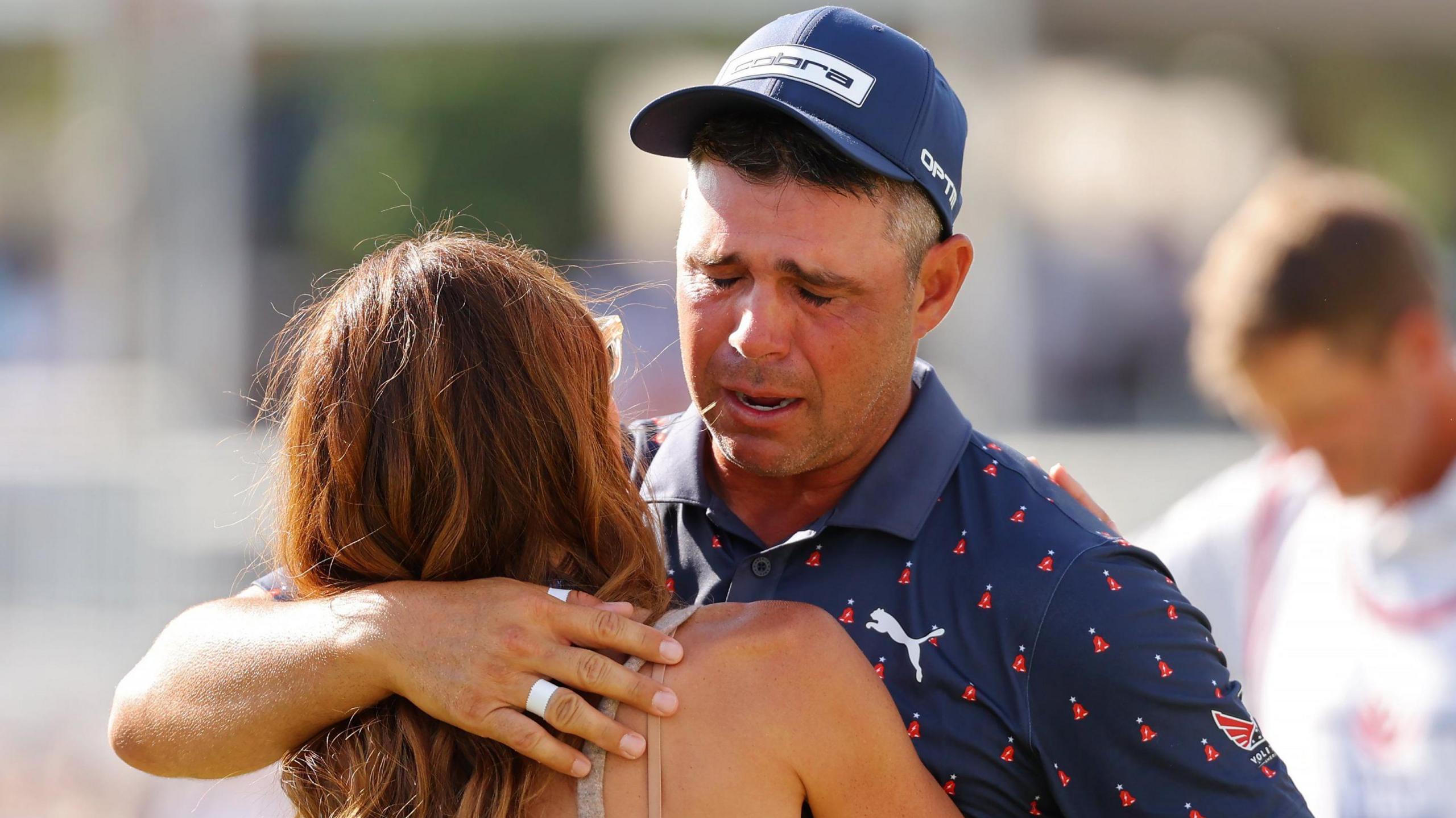 American golfer Gary Woodland cries as he embraces his wife Gabby after winning the Houston Open