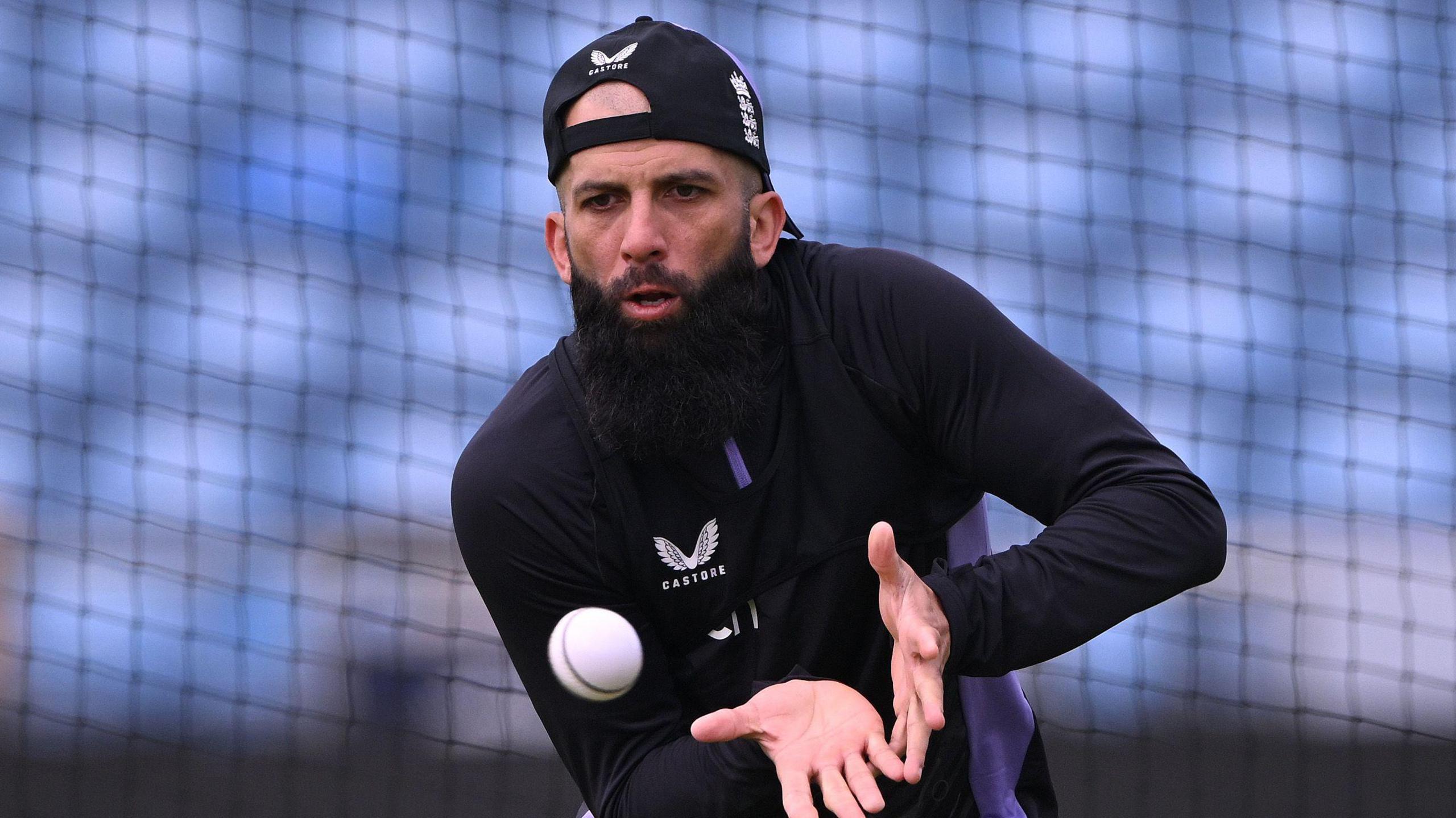 Moeen Ali catches the ball