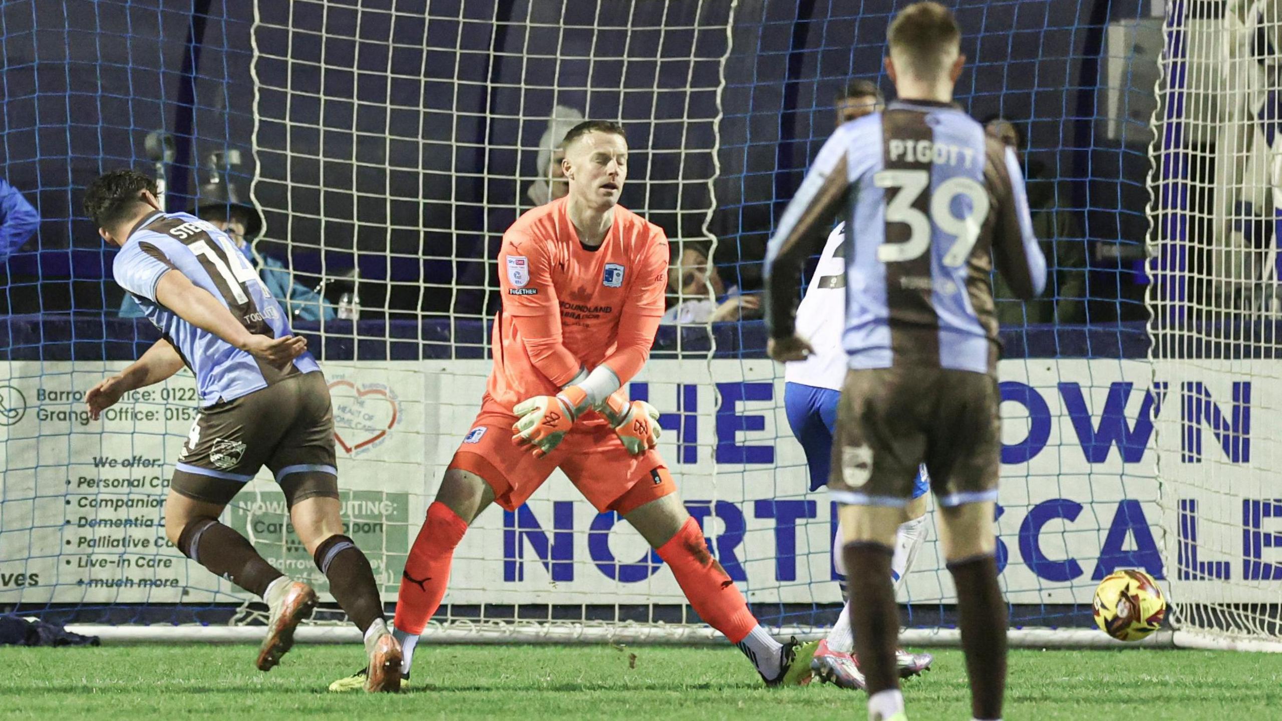 Matt Stevens flicks the ball past Paul Farman for Wimbledon's second goal