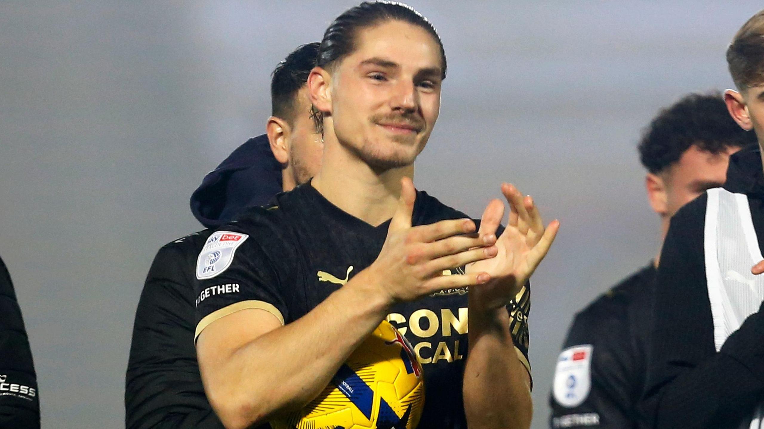 Lorent Tolaj applauds Plymouth fans after his hat-trick at Doncaster Rovers