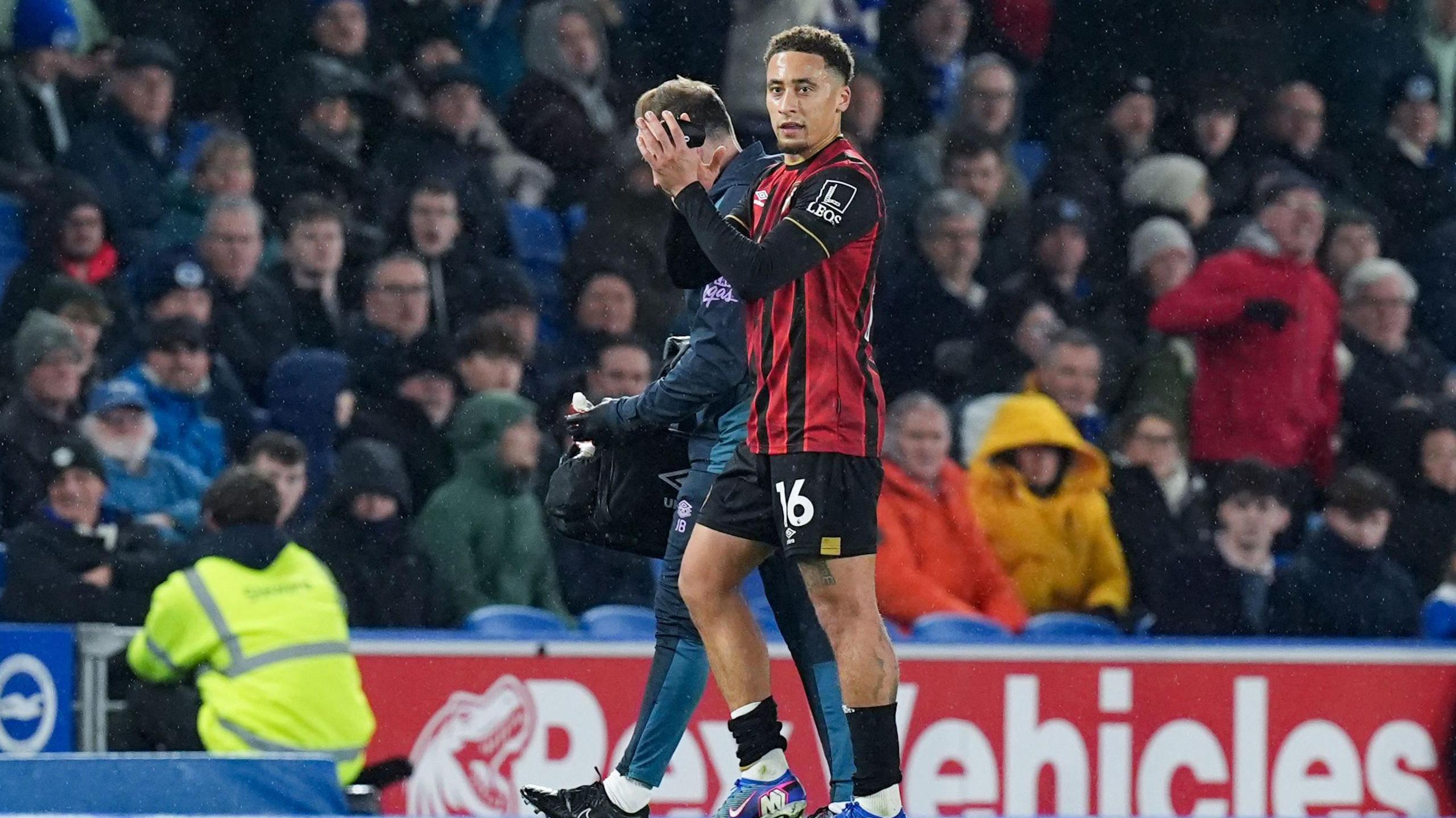 Marcus Tavernier exits the pitch with a medic