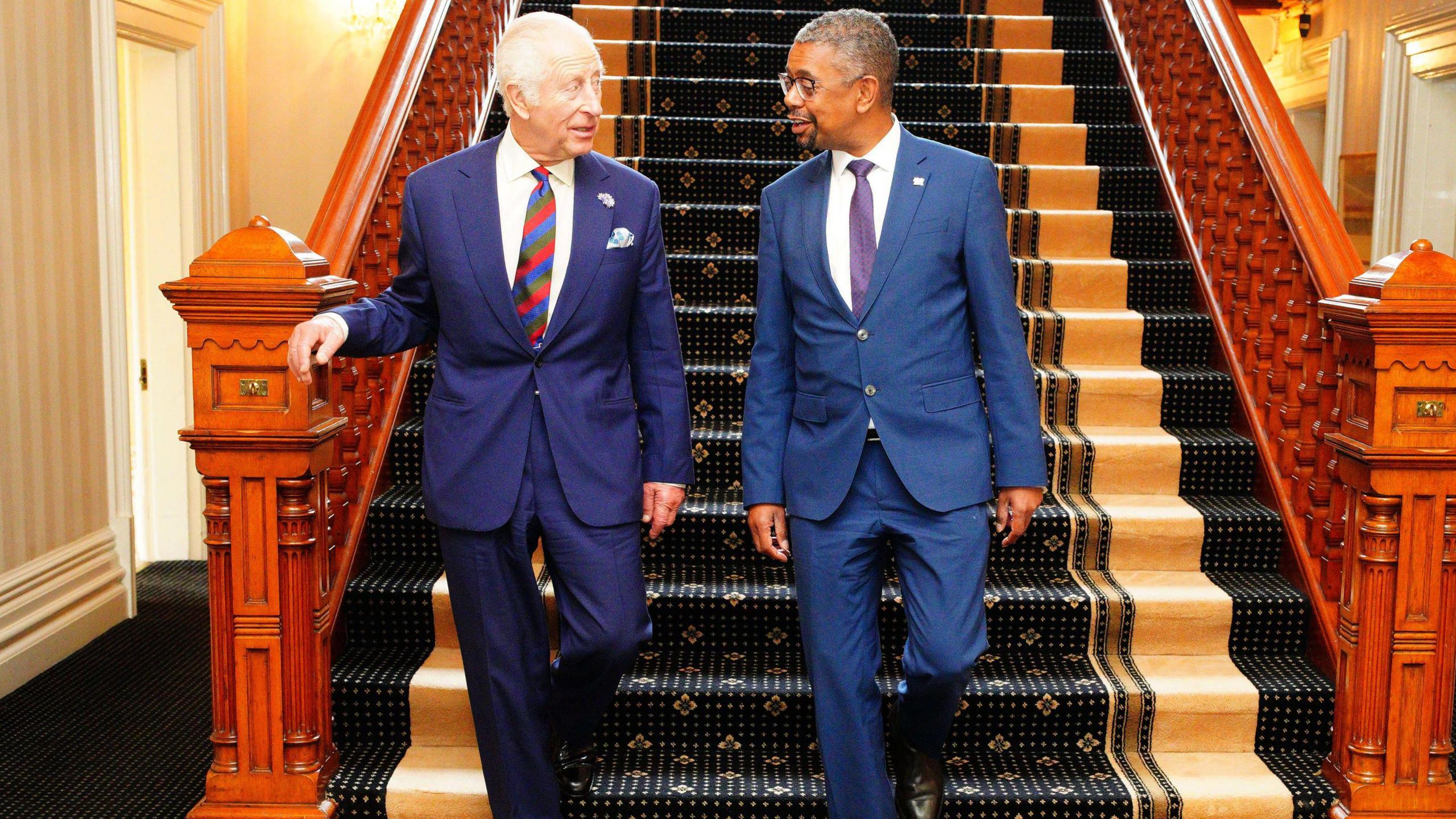 The King and Vaughan Gething walking downstairs at the Mansion House in Cardiff 