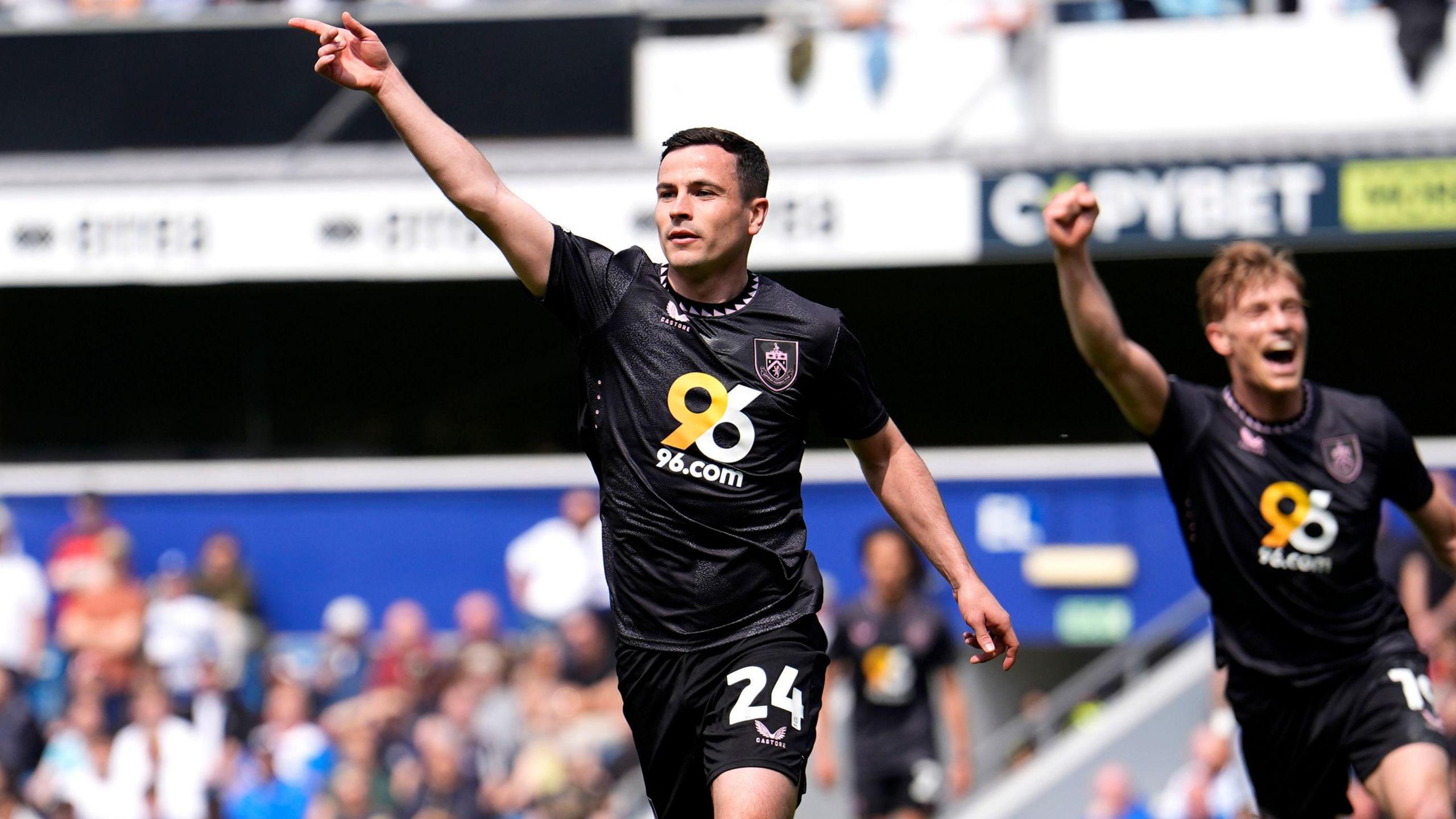 Josh Cullen [left] celebrates after scoring Burnley's first goal against QPR