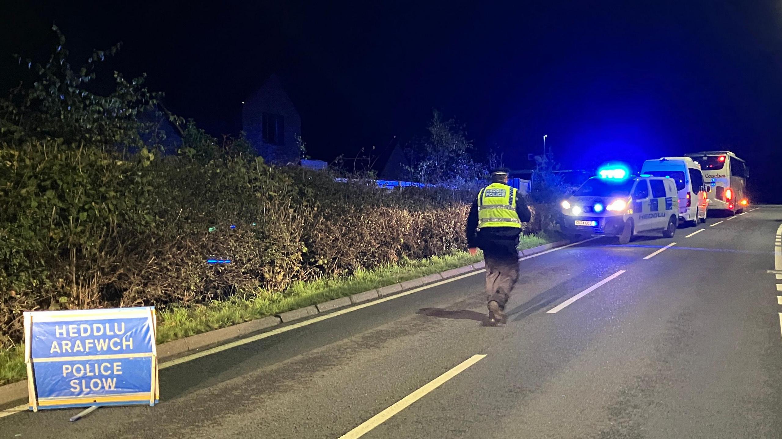 Police on the road after a rail crash was reported in Powys