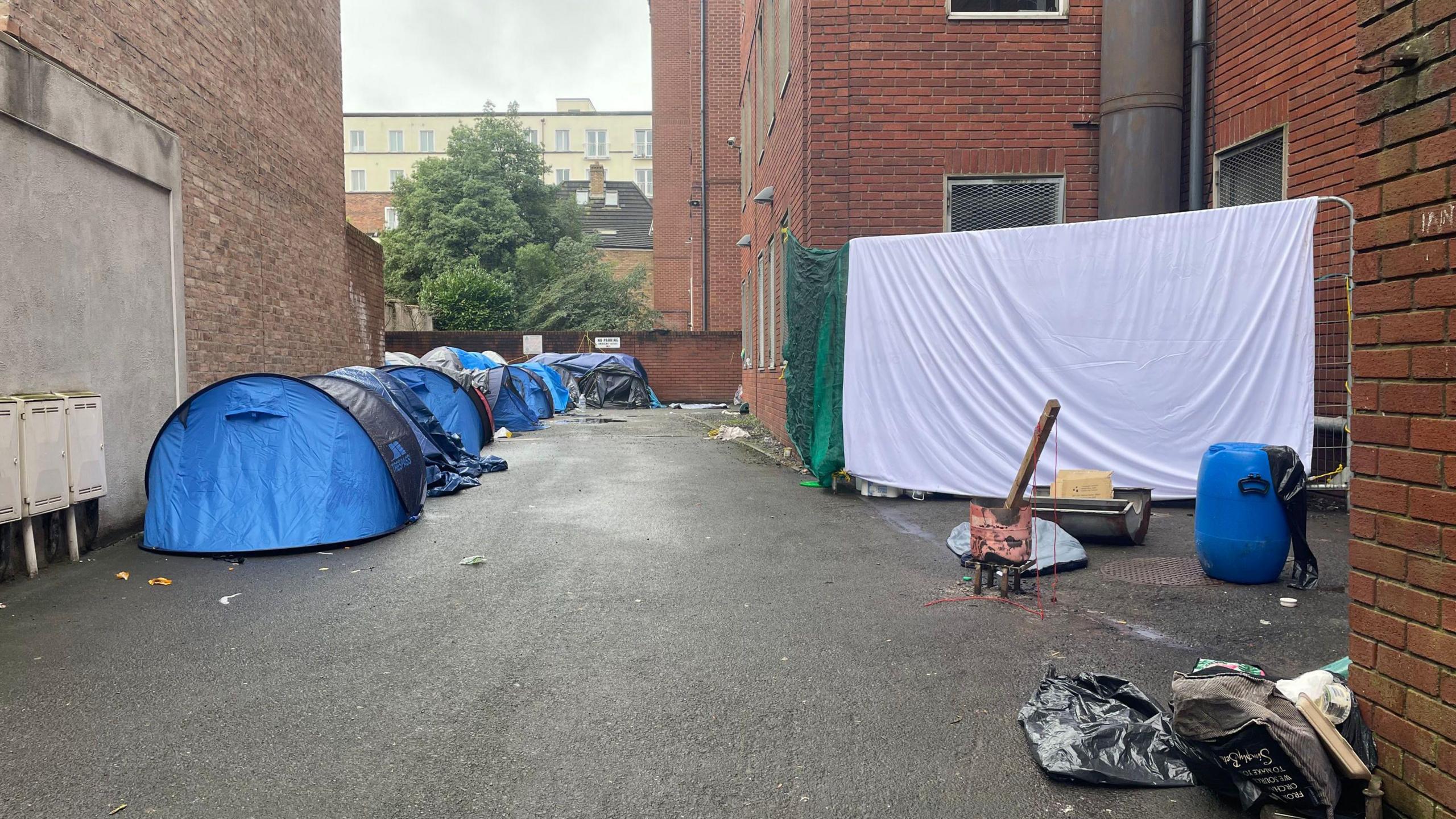 Tents are cleared after men who had been camping at the International Protection Office on Mount Street were taken by bus to a site at Crooksling on Saturday morning