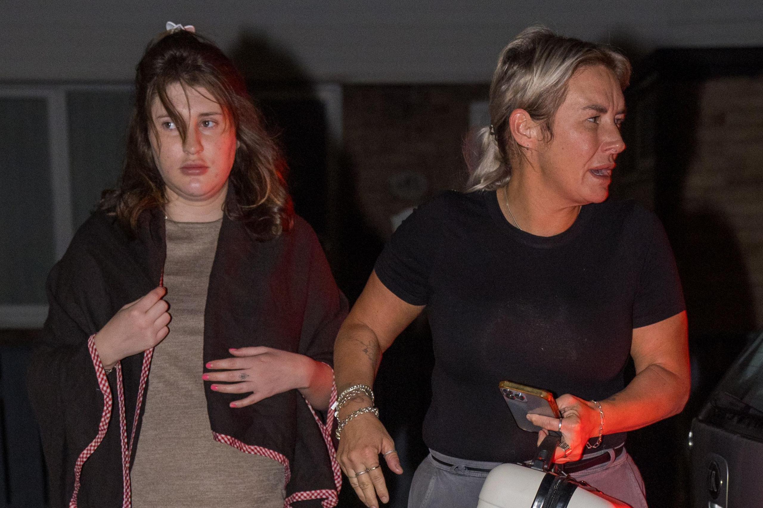 Bella Culley is walking from the car to her house with her mother Lyanne Kennedy. Miss Culley, on the left is wearing a brown shawl and has long brown hair. Ms Kennedy is wearing a black T-shirt and grey trousers. Her blonde hair is pulled back in a ponytail.