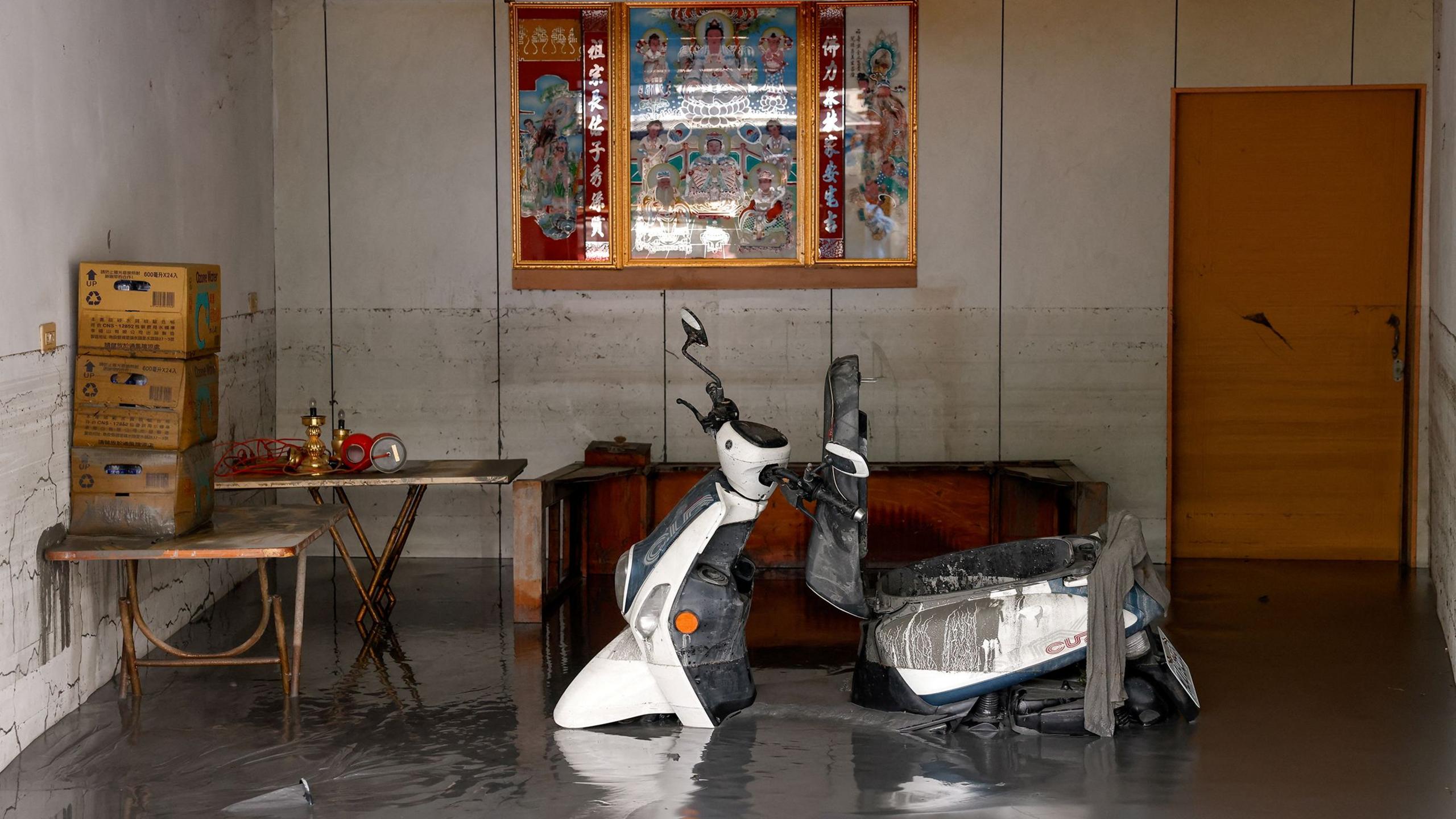 A scooter stands in mud inside a flooded building after Super Typhoon Ragasa in Hualien, Taiwan,