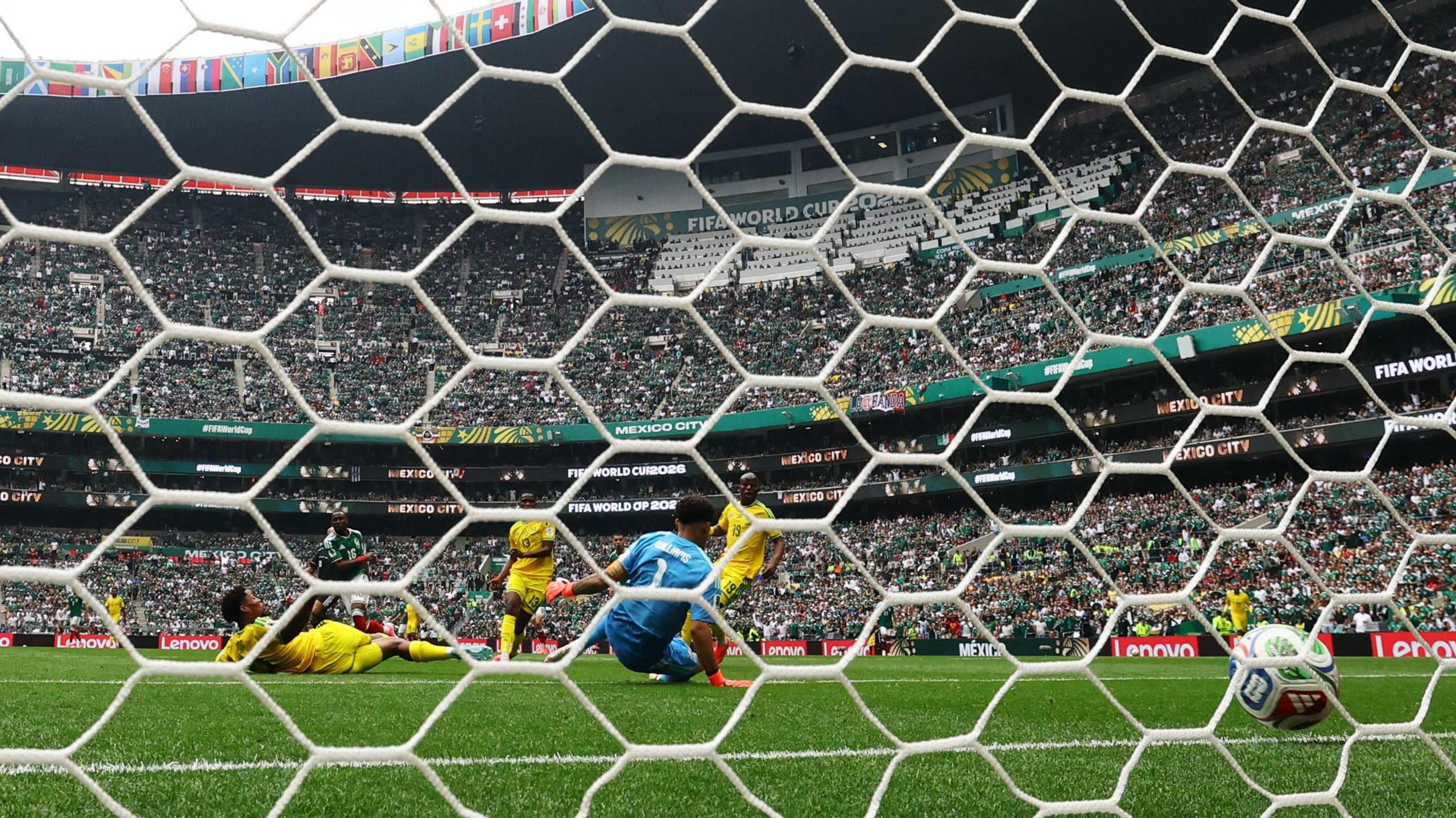 Mexico's Julian Quinones scores their first goal past South Africa's Ronwen Williams.