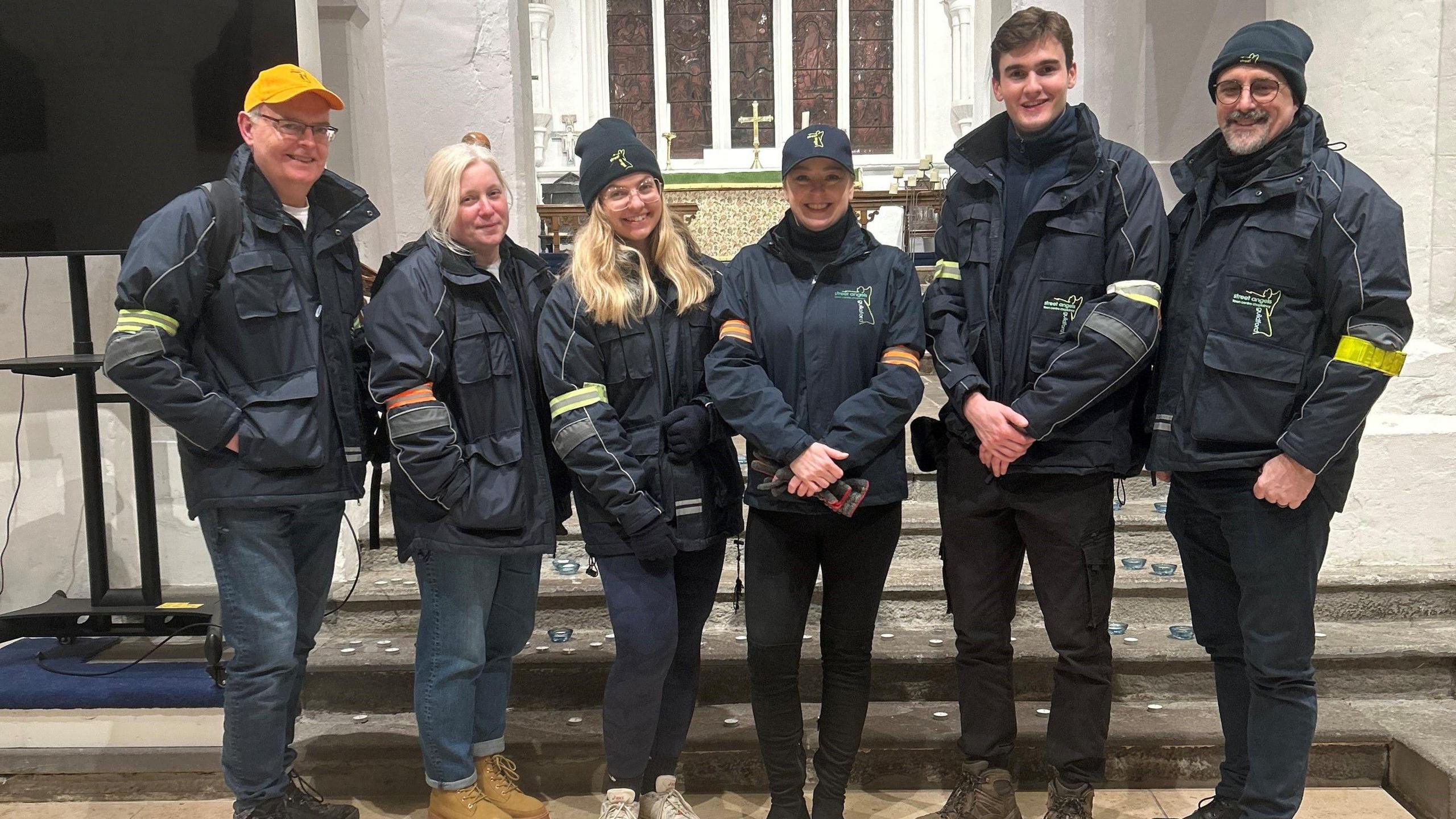 Surrey Police and Crime Commissioner Lisa Townsend stands in Guildford town centre flanked by five members of the Street Angels team, all wearing branded jackets.