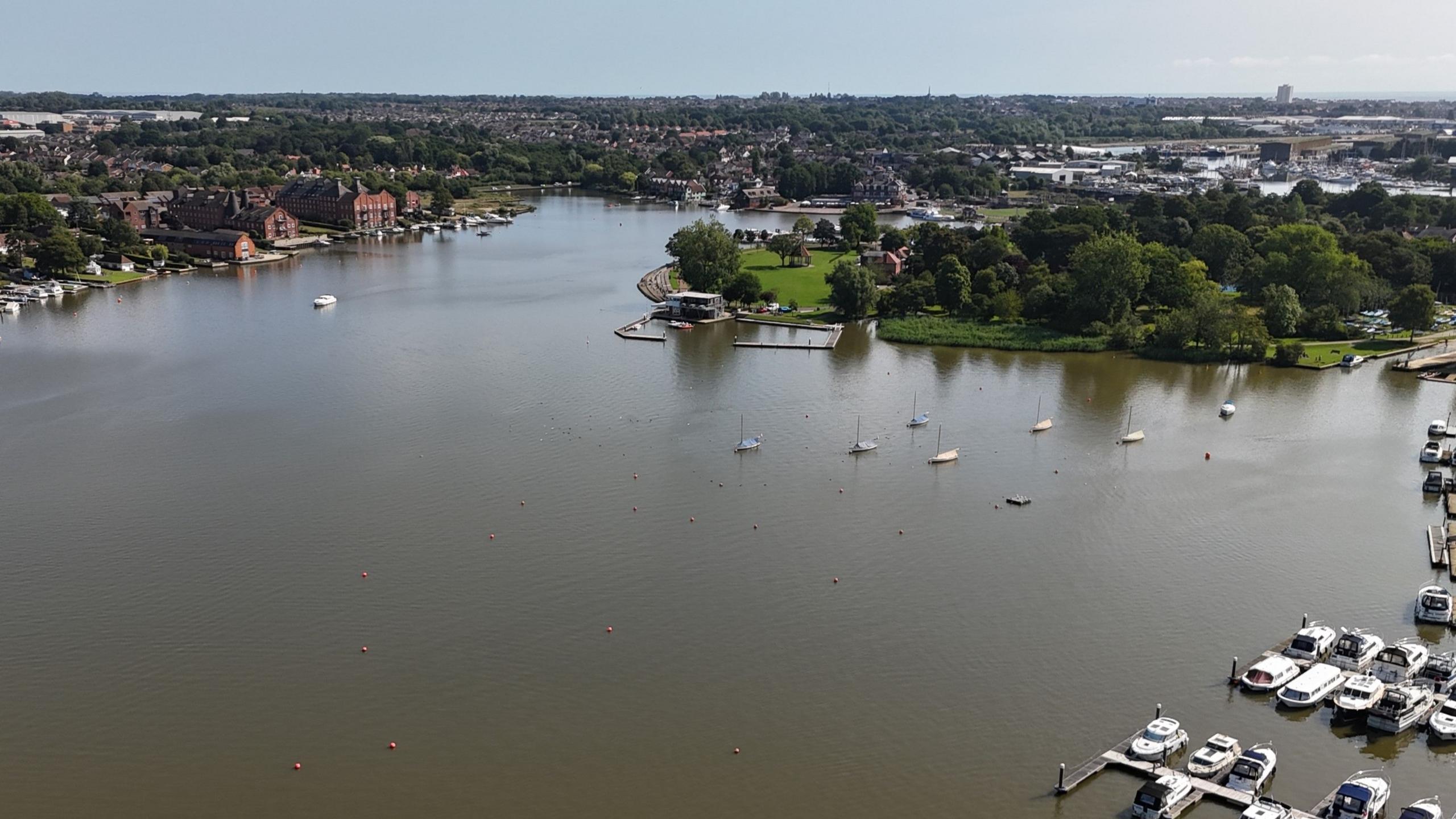 A general view of the Oulton Broad marina. Boats and yachts rest in the water.