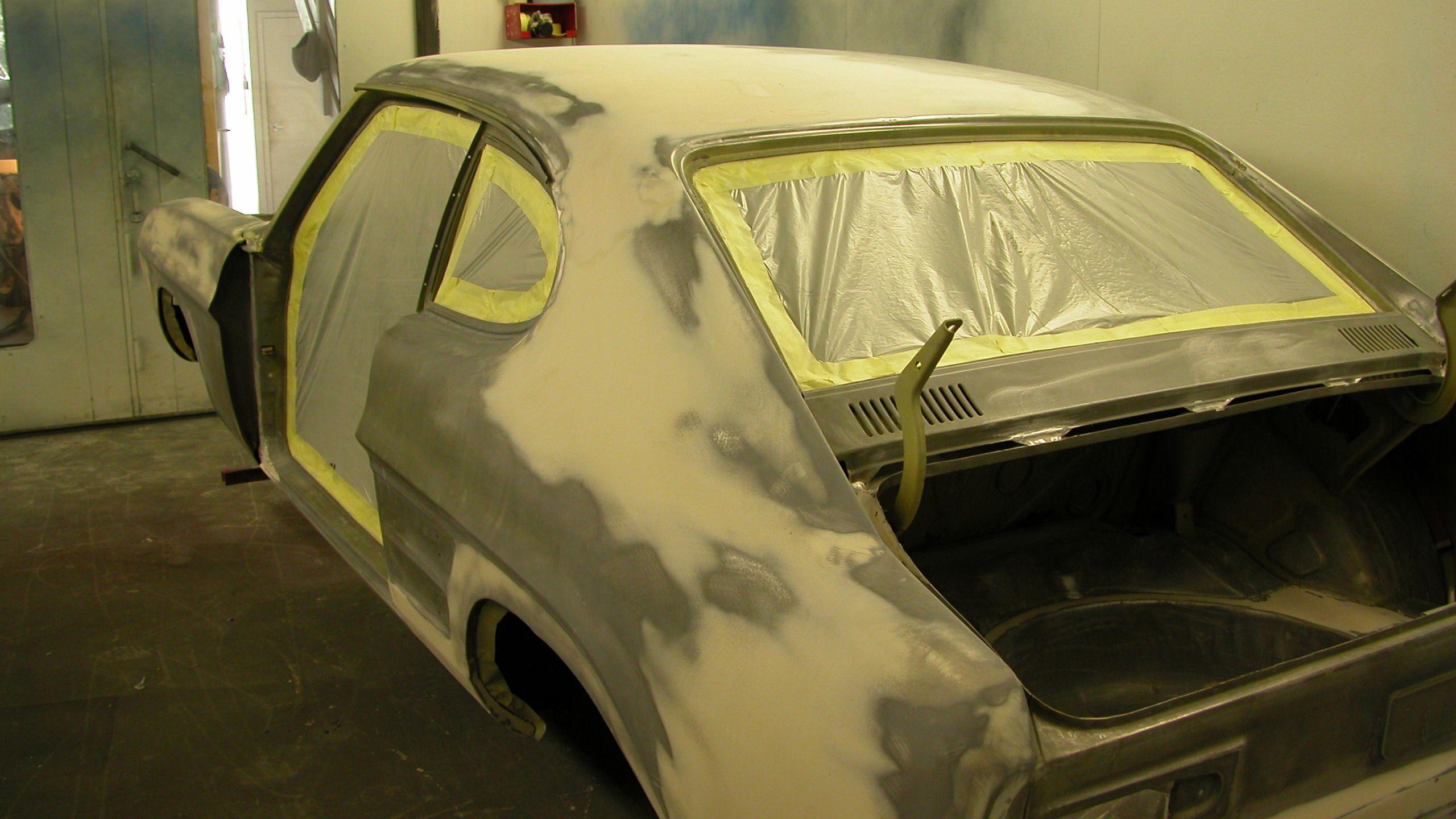 The car stiped down to bare metal and being prepared to be painted. 