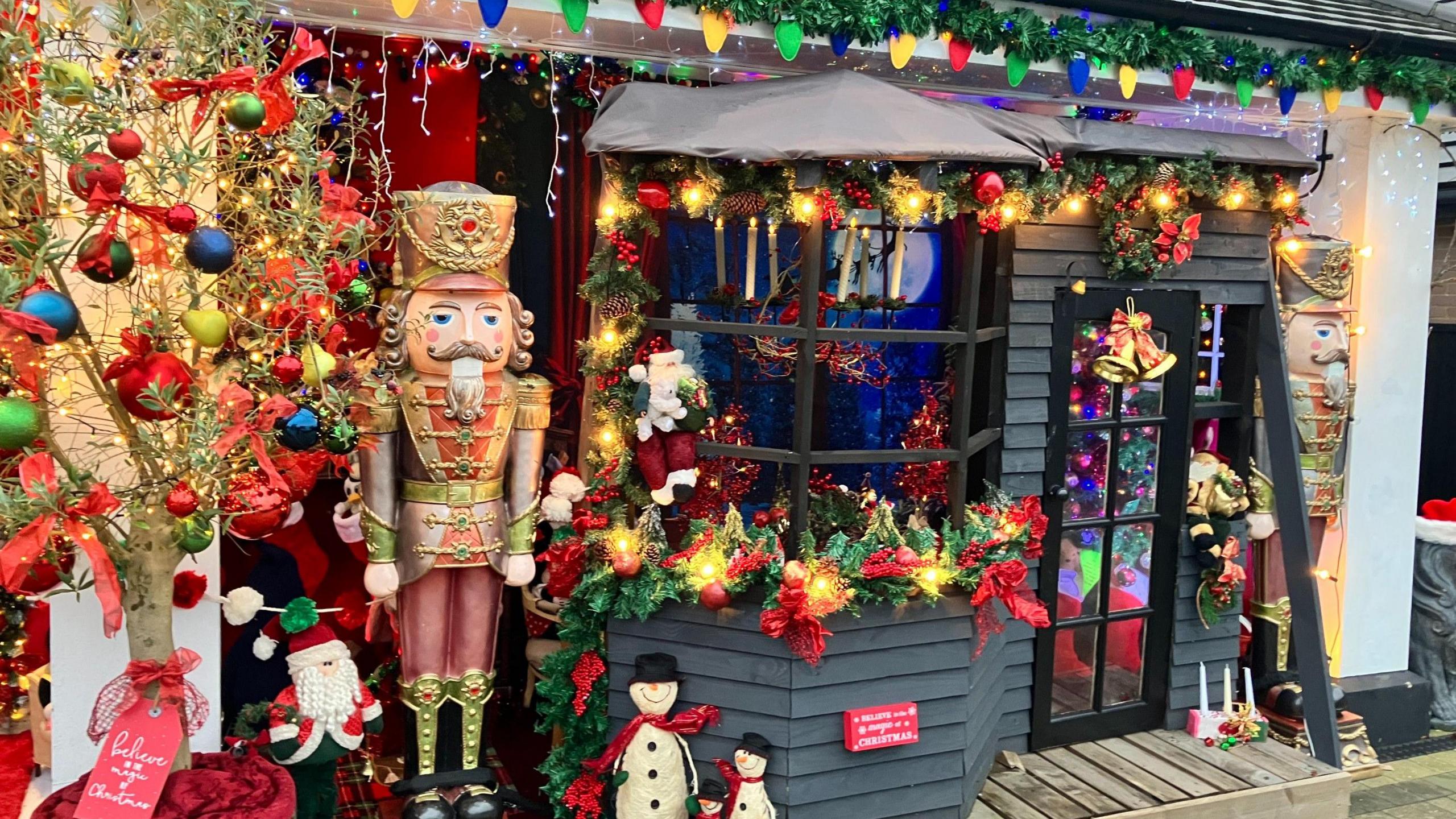 A selection of Christmas decorations standing outside the house.